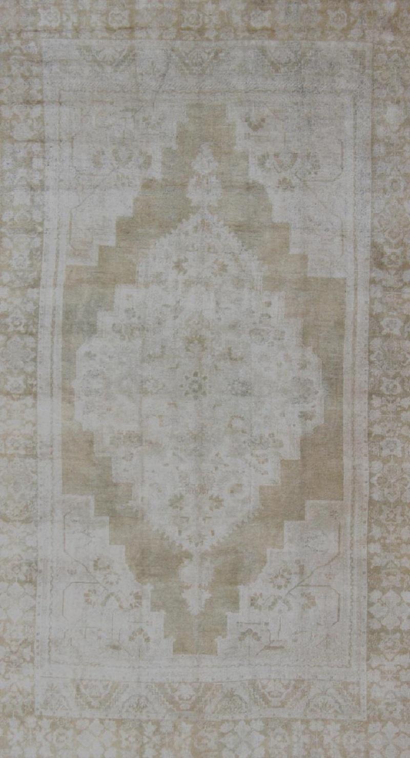 Turkish Medallion Design Vintage Oushak Rug in Muted Tones of Faded Yellow and Neutrals For Sale