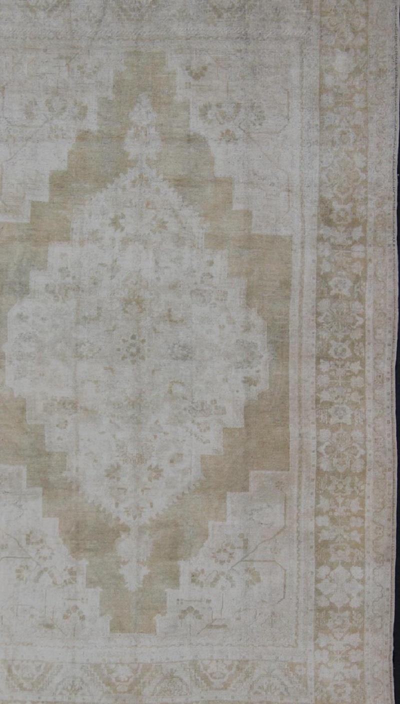 Hand-Knotted Medallion Design Vintage Oushak Rug in Muted Tones of Faded Yellow and Neutrals For Sale