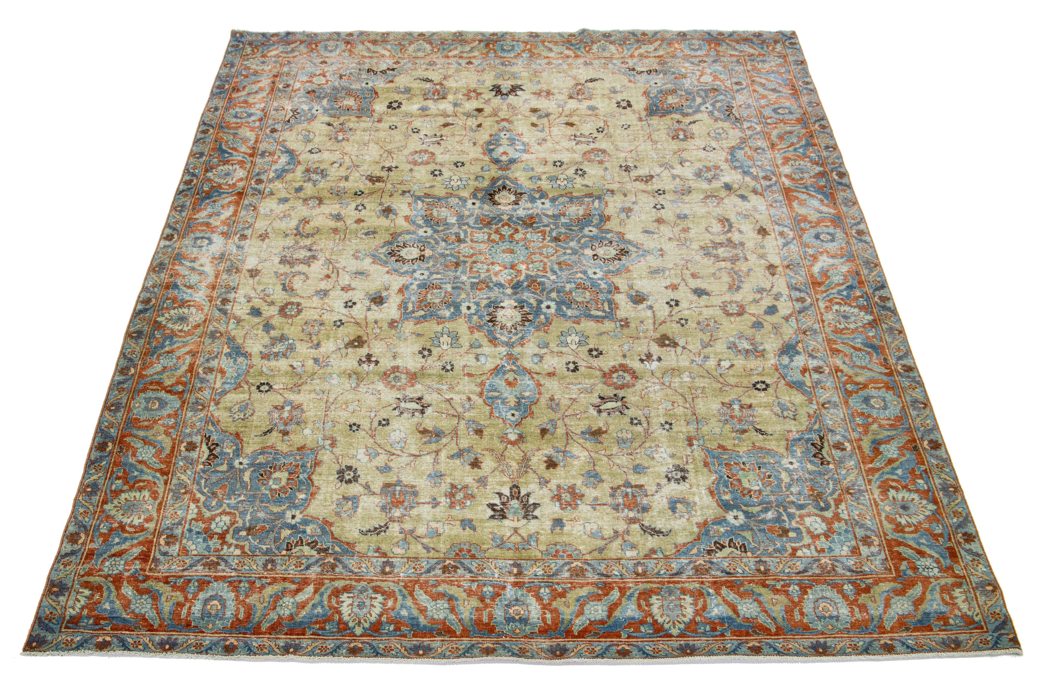 This beautifully handcrafted Persian Tabriz wool rug displays a classic floral pattern. The contrast created by the beige-tan background accentuates the medallion floral design, which features shades of blue and orange.

This rug measures  9'3