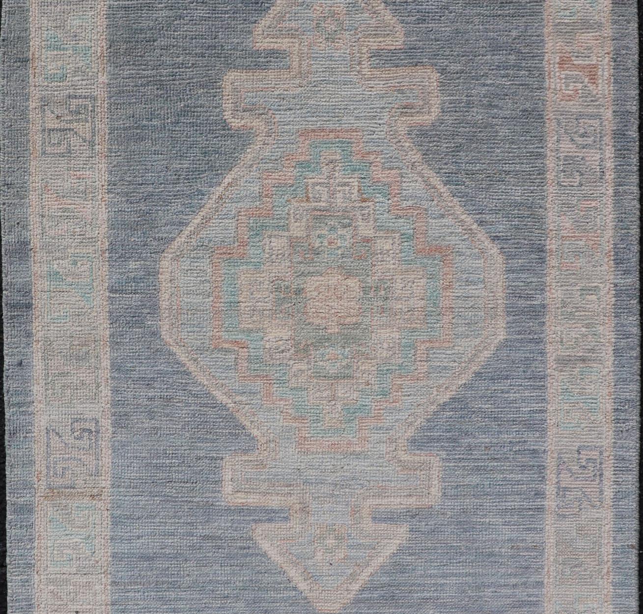 Measures: 2'7 x 3'11 
Medallion Designed Modern Oushak with Blue Background and Cream Border. Keivan Woven Arts; rug AWR-12400, Early 21st Century.

This modern Oushak features large medallions in the center of a blue background, centering around
