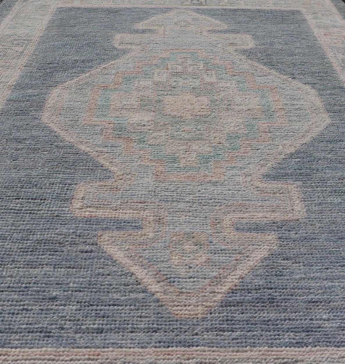 Medallion Designed Modern Oushak with Blue Background and Cream Border In New Condition For Sale In Atlanta, GA