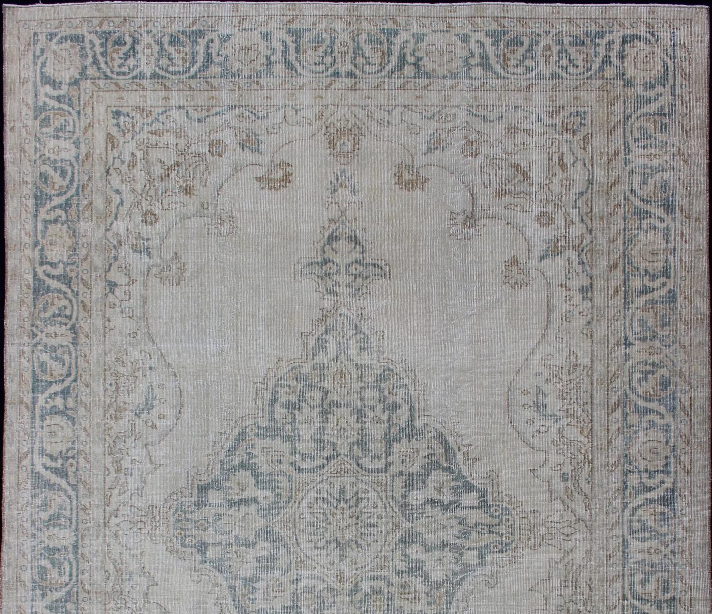 Taupe, cream and blue Oushak rug vintage from Turkey with medallion design of etched motifs, Keivan Woven Arts/rug /EN-179688, country of origin / type: Turkey / Oushak, circa 1950.

Measures: 6'10 x 10'3.

This striking vintage Turkish Oushak rug