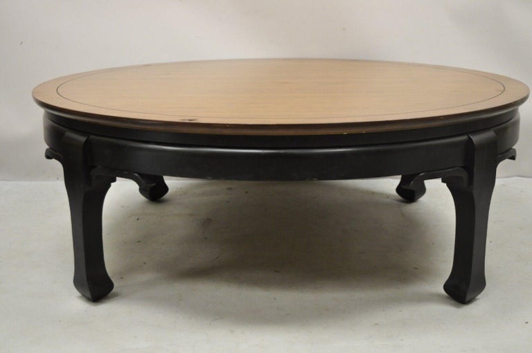 Medallion Limited oriental Chinoiserie James Mont style round ming coffee table. Item features a round custom glass top, ming style legs, black ebonized base, brown wooden top, original label, quality American craftsmanship, great style and form.