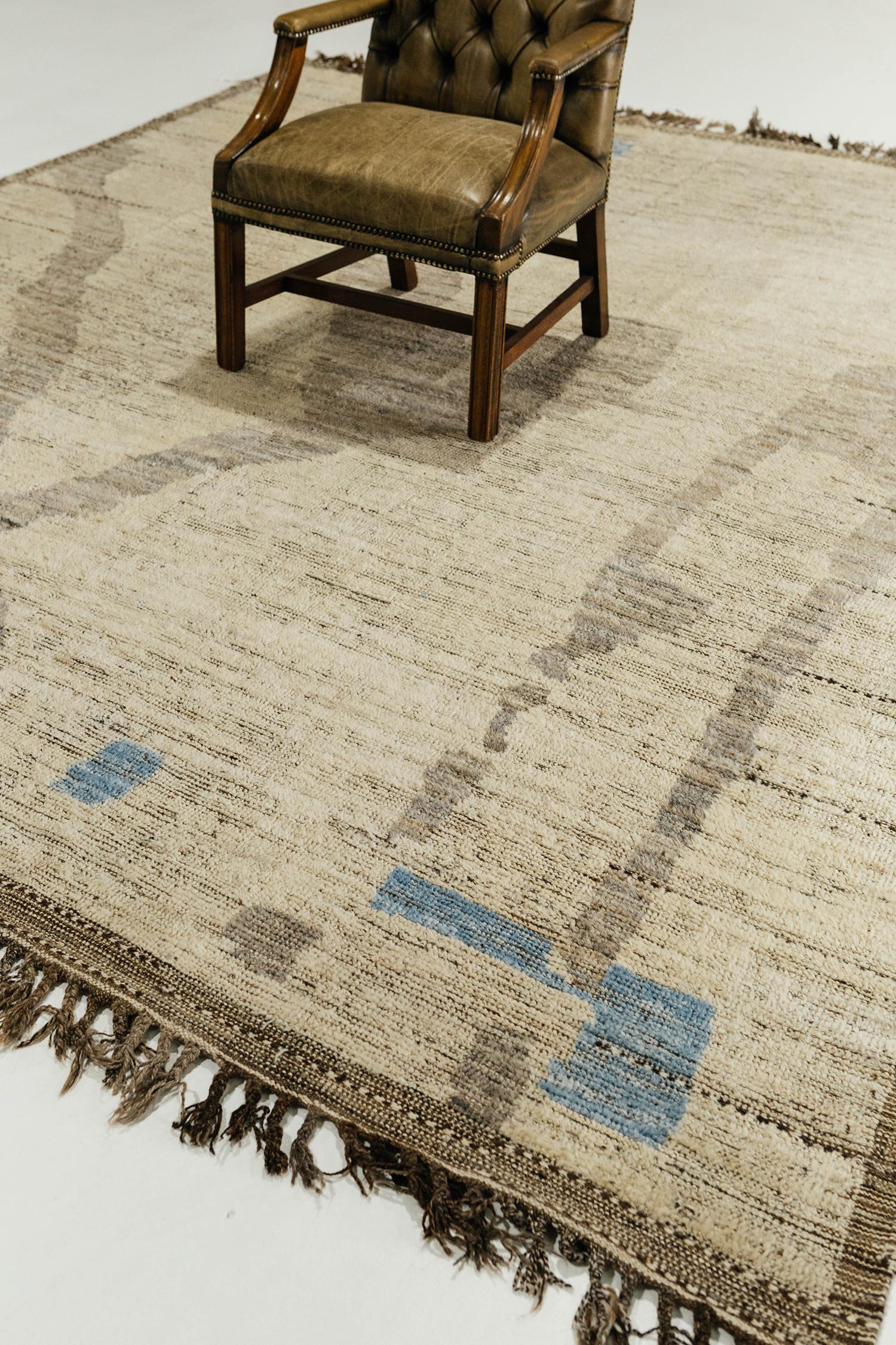 Meden' is an earth-toned natural wool rug and a modern interpretation of the Moroccan world. This rugs irregular shapes and colors resemble the fibers of nature and their ability to be used for crafts such as cords and basketry. Designed in Los