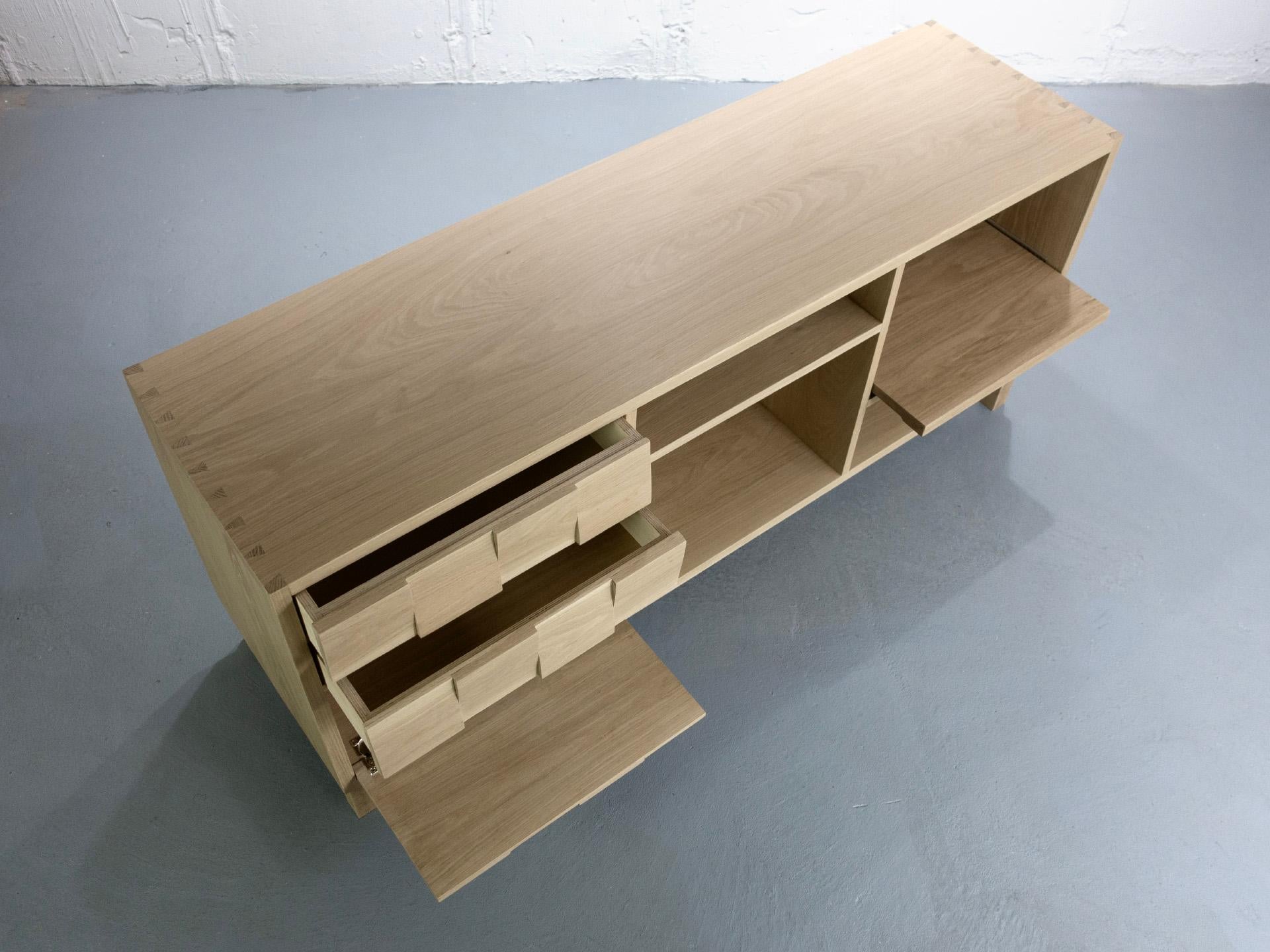 Minimalist MEDIA CREDENZA in white oak featuring a push to open turntable shelf. For Sale