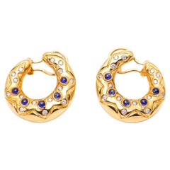 MEDIALUNA earrings in gold and diamonds.