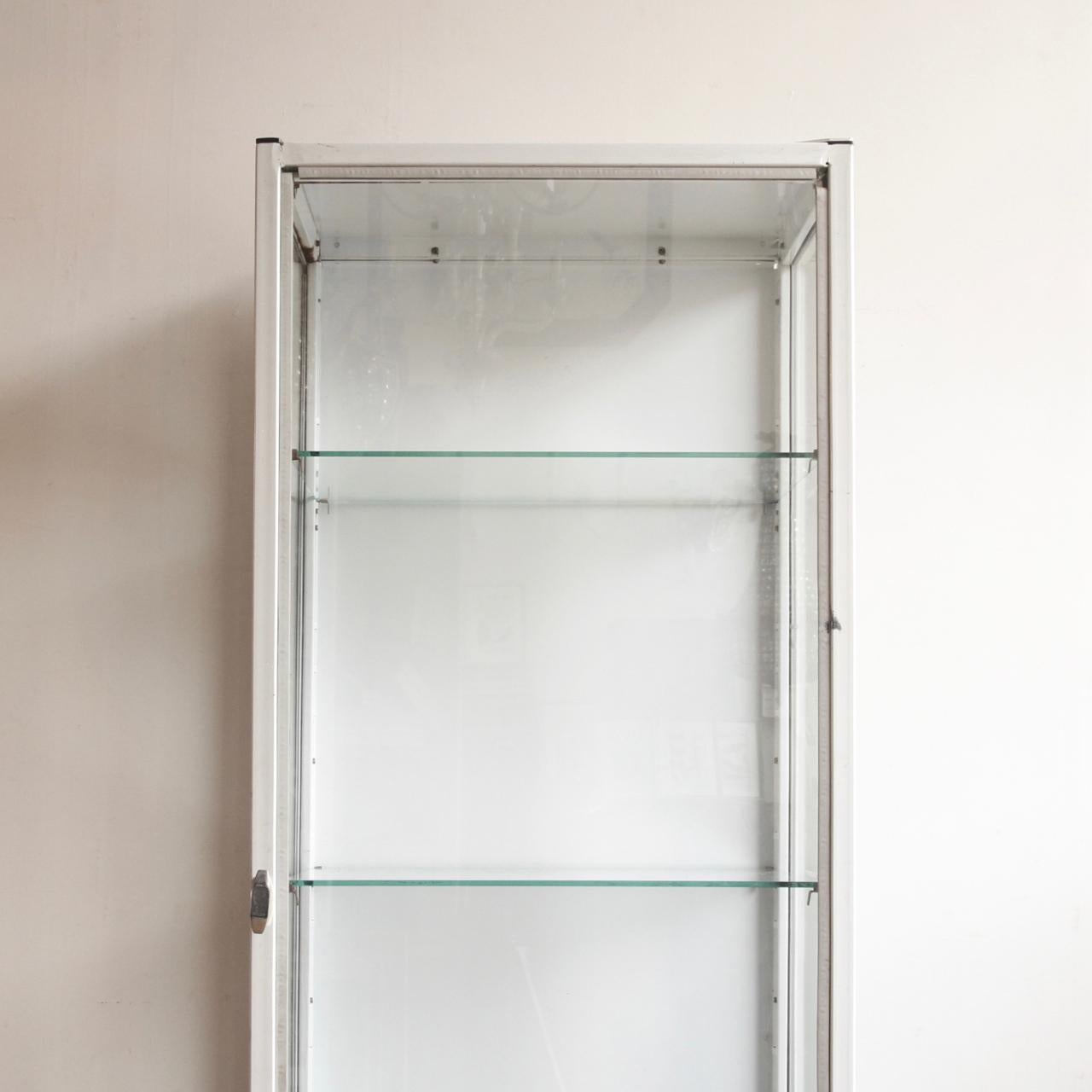 1940s, eastern European medical cabinet. This cabinet would have been used in a hospital or medical unit, for the storage of medicine and/or medical instruments. The cabinet is made from painted steel and features two glass shelves, it would make an