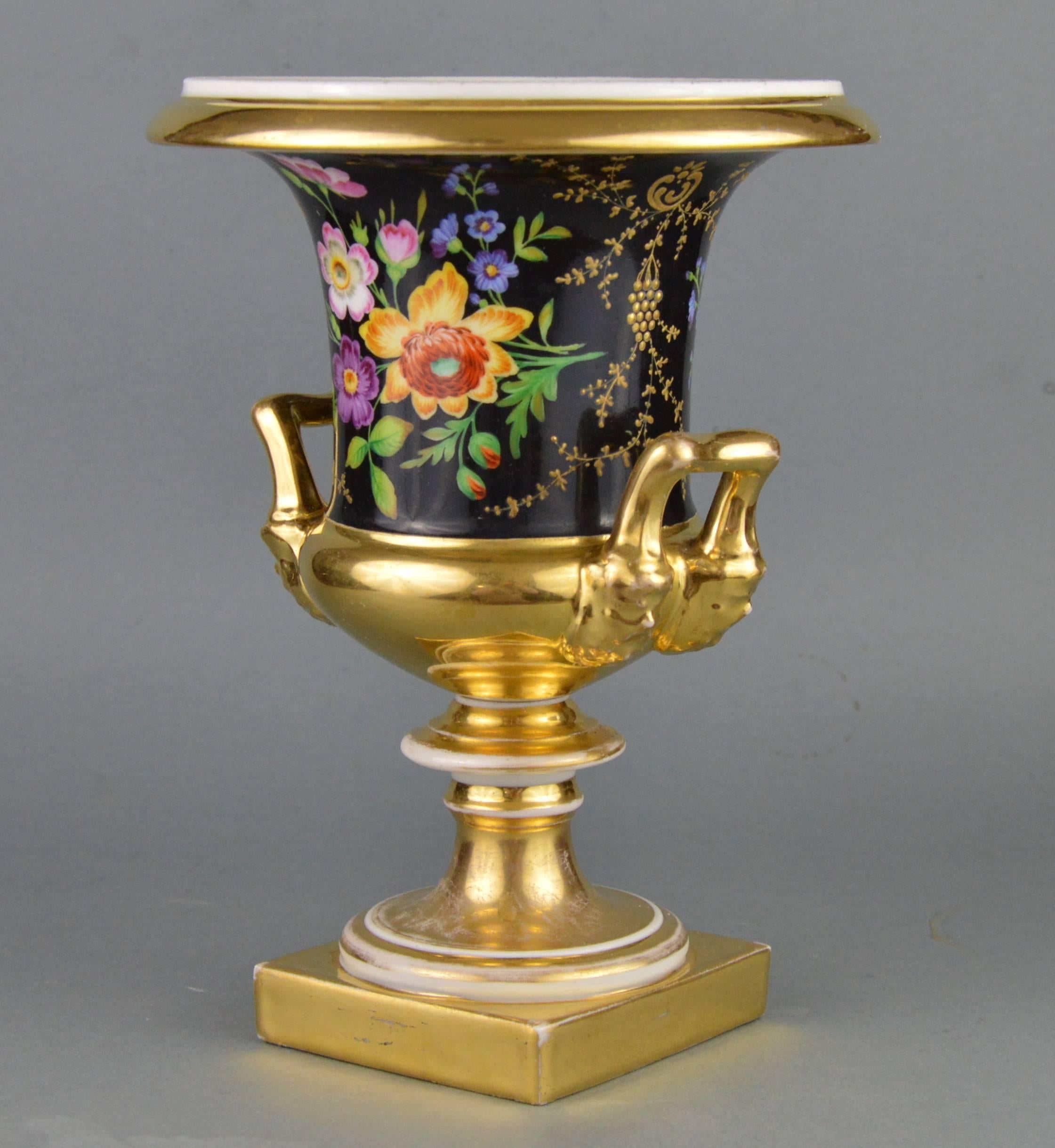 Medici porcelain vase. Fine quality hand-painted flower ornamented decoration on a black background (one of the most complicated colours to handle in porcelain decoration). Satire heads shaped gilt handles. Typical 1820-1840 Jacob Petit romantic