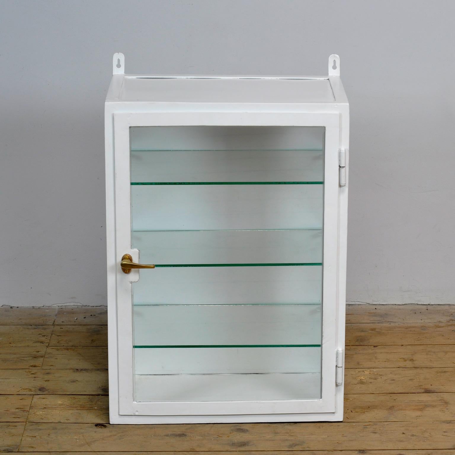 Medicine cabinet from the 1930’s. The cabinet is produced in Hungary and is made of thick iron and glass. Originating from a hospital in Budapest. The cabinet has recently been powder-coated.