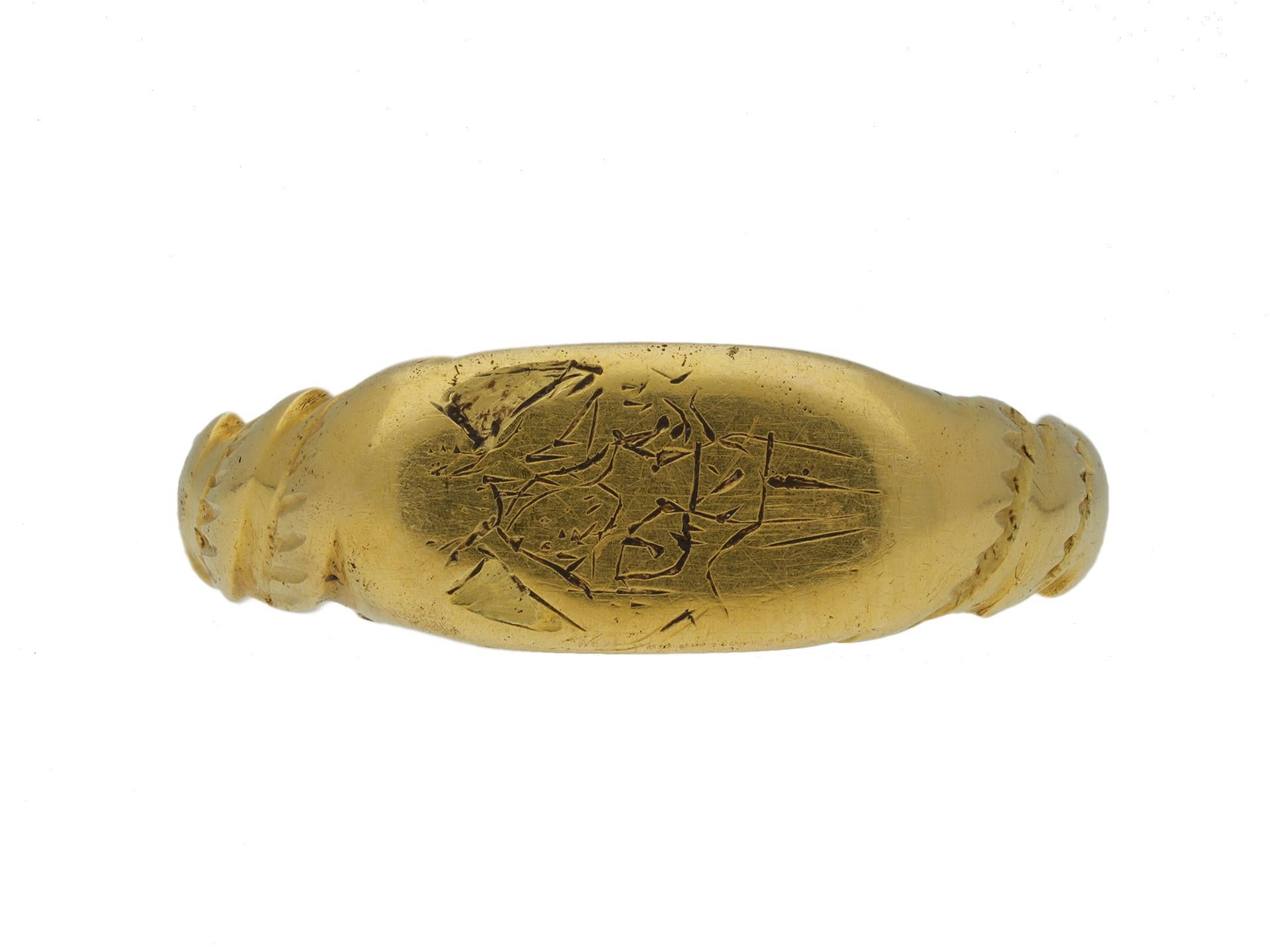 Medieval iconographic ring with the holy trinity. A yellow gold ring with an oval bezel finely engraved with a religious scene featuring the holy trinity with a crucified Jesus in the centre, God the father behind and above, his arms supporting