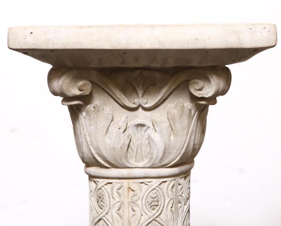 Medieval cast-stone columns, elaborately carved with detailed stem of arabesque and figural frieze on basket weaver base. Minor age-appropriate cracks and losses.