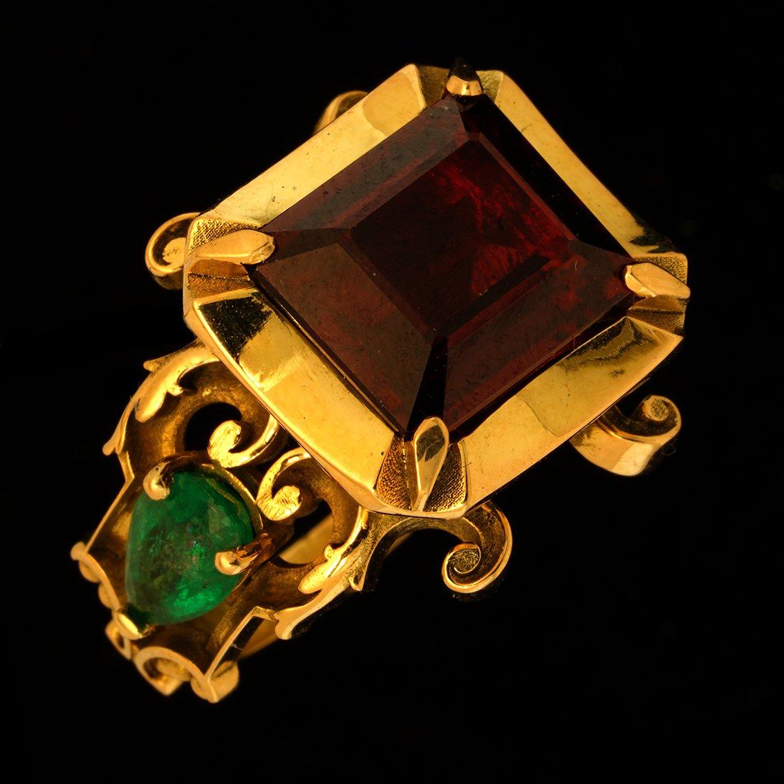 Conjuring the colors and fine embroidery work of robes worn by medieval kings and queens, this stately ring is exquisitely handcrafted in 18kt yellow gold and features a rich 4 claw set 11mm x 13mm 7.9ct garnet, it’s color offset beautifully against
