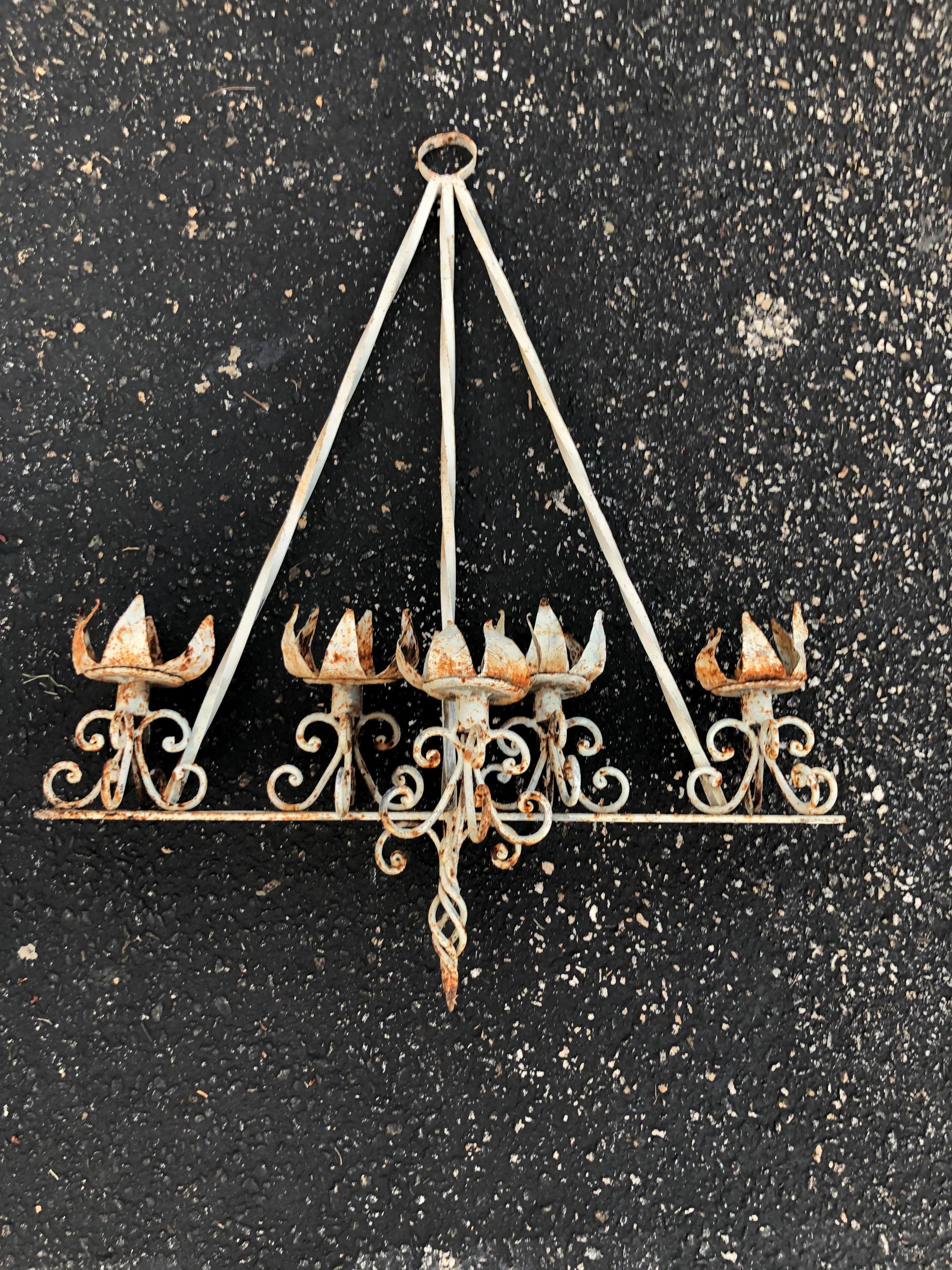 Medieval style iron wall torchiere. The perfect romantic touch for your home. Fill with candles above a bath tub or use on a porch or outside barn wall. Nice rustic whitewashed look.