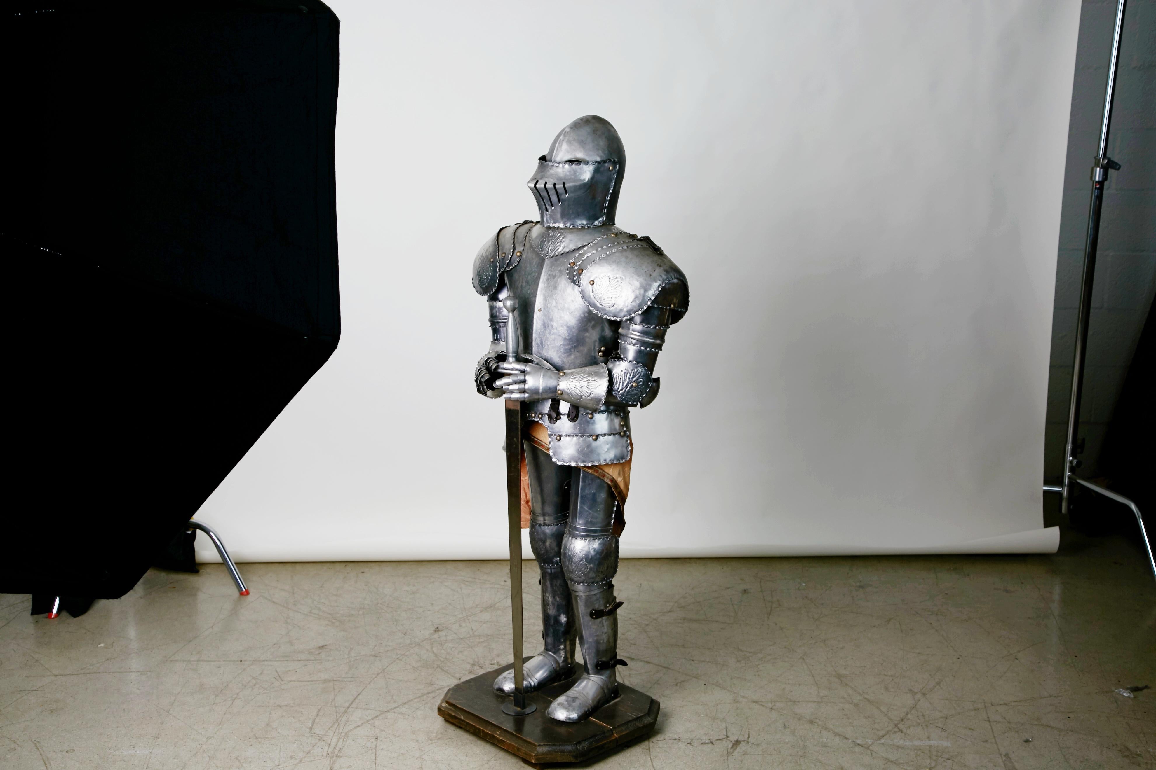 Looking for a conversation starter for your space? This impressive Medieval-style suite of fully articulated armor on display stand is complete with shoes, gloves, gauntlets, helmet and sword. Standing at approximately 55