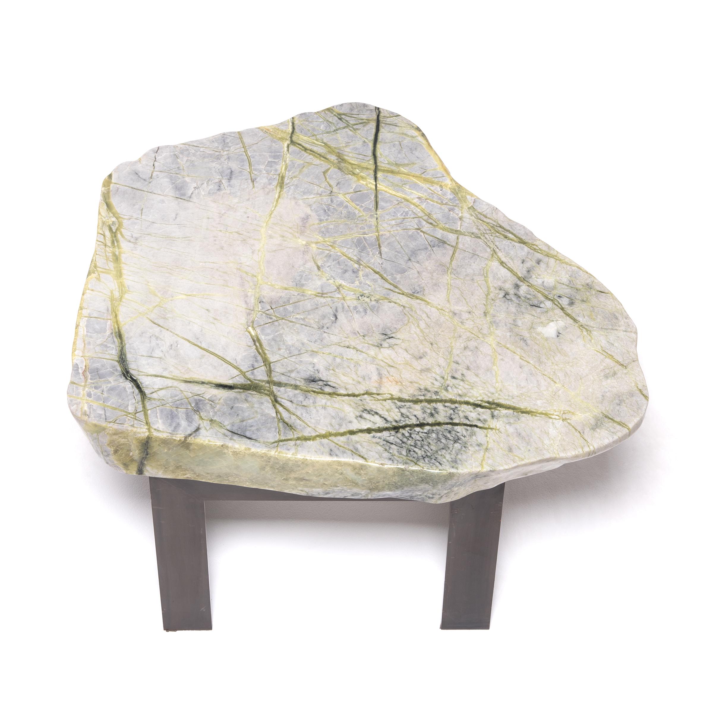 Prized by ancient scholars, meditation stones provided inspiration for poetry, painted landscapes, or brushed calligraphy. Supported by a custom Parson's-style steel base, the greenery stone that tops this table is composed of jadeite, moss agate,