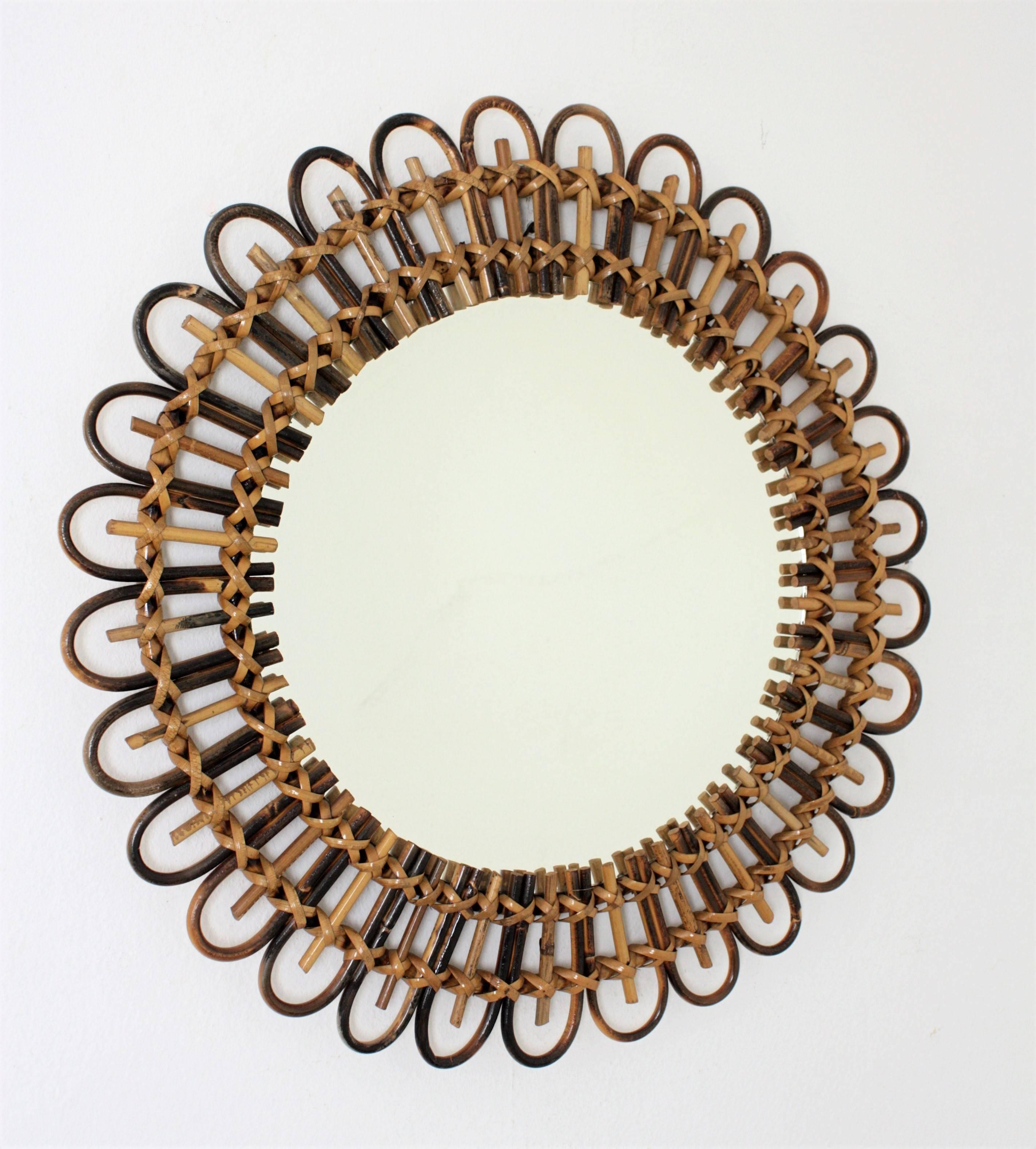 Beautiful French handcrafted rattan and bamboo flower burst mirror. This lovely mirror has alternating petals in two different colors that highlight its beauty. Lovely to place it alone or creating a wall decoration with other rattan or bamboo