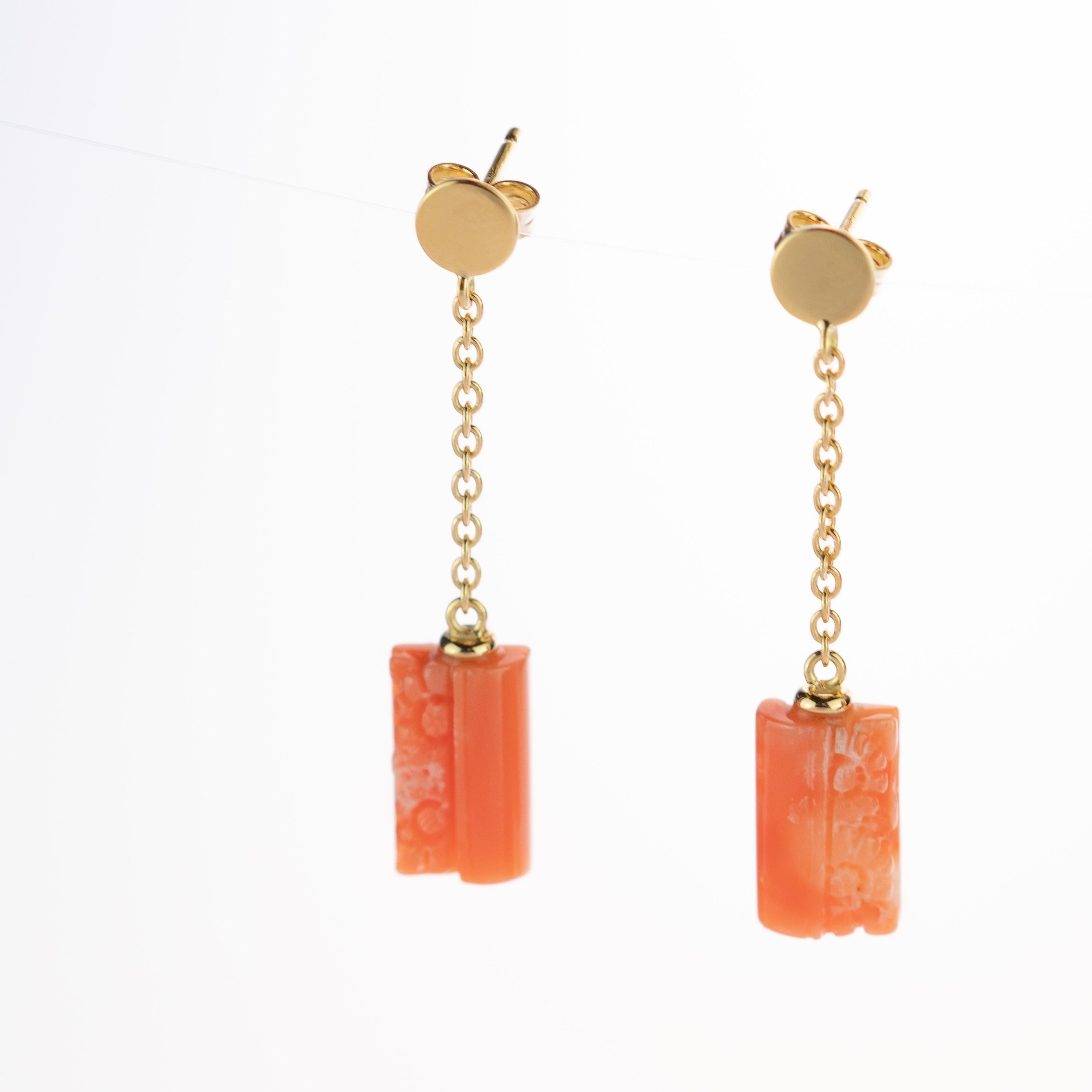 One of a kind rectangular and cylindrical mediterranean natural coral earrings. A delicate gold circle piece with two delicate 18 karat yellow gold chains ending in marvellous carved coral piece. Evoking all the italian tradition resulting in a