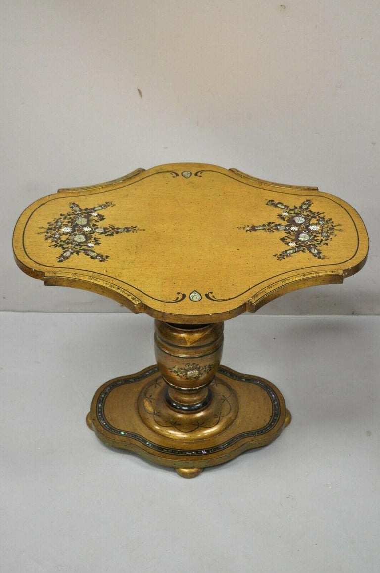 Vintage Spanish Mediterranean style gold leaf low pedestal side tables with mother of pearl inlay - a pair. Item features custom glass tops, carved pedestal base, mother of pearl floral inlay, gold leaf finish, nice low form. Circa mid 20th century.