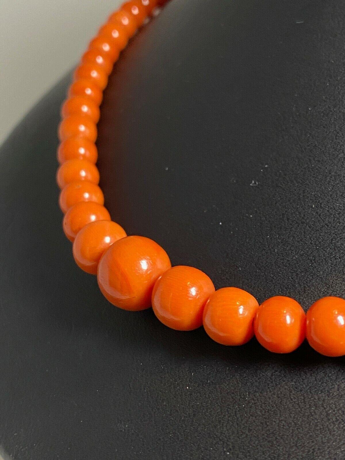Fine & Rare Orangey Red Coral Bead Necklace 

Composed of 53 natural coral beads of approximately 4.2 to 13 mm., 
of stunning red to orangey red colour 

completed by a clasp set with oval cabochon natural coral of 4.5mm x 9.9mm 
within 18K yellow