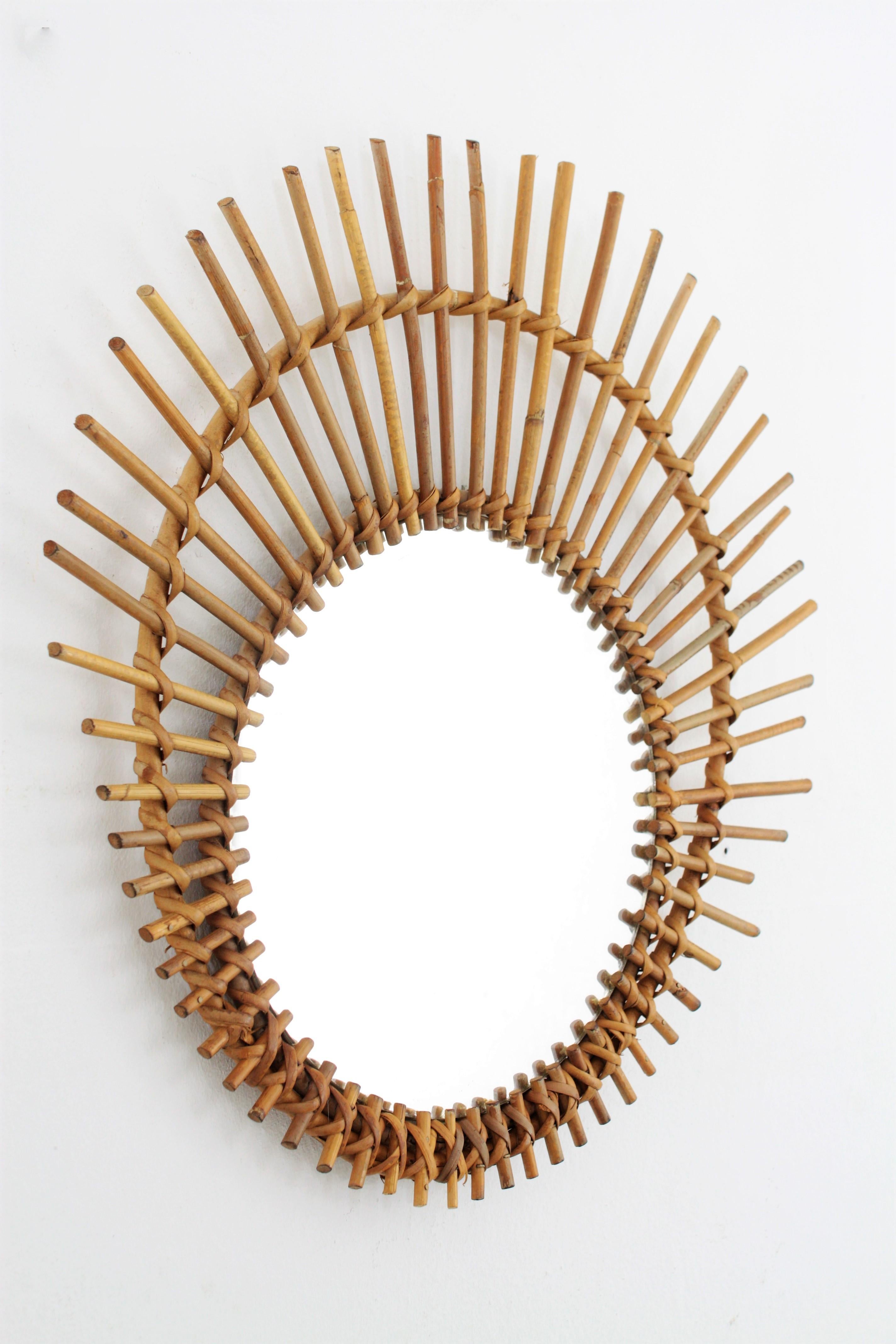 Mid-Century Modern Mediterranean Rattan Wicker Asymmetric Ovoid Sunburst Mirror, France, 1960s