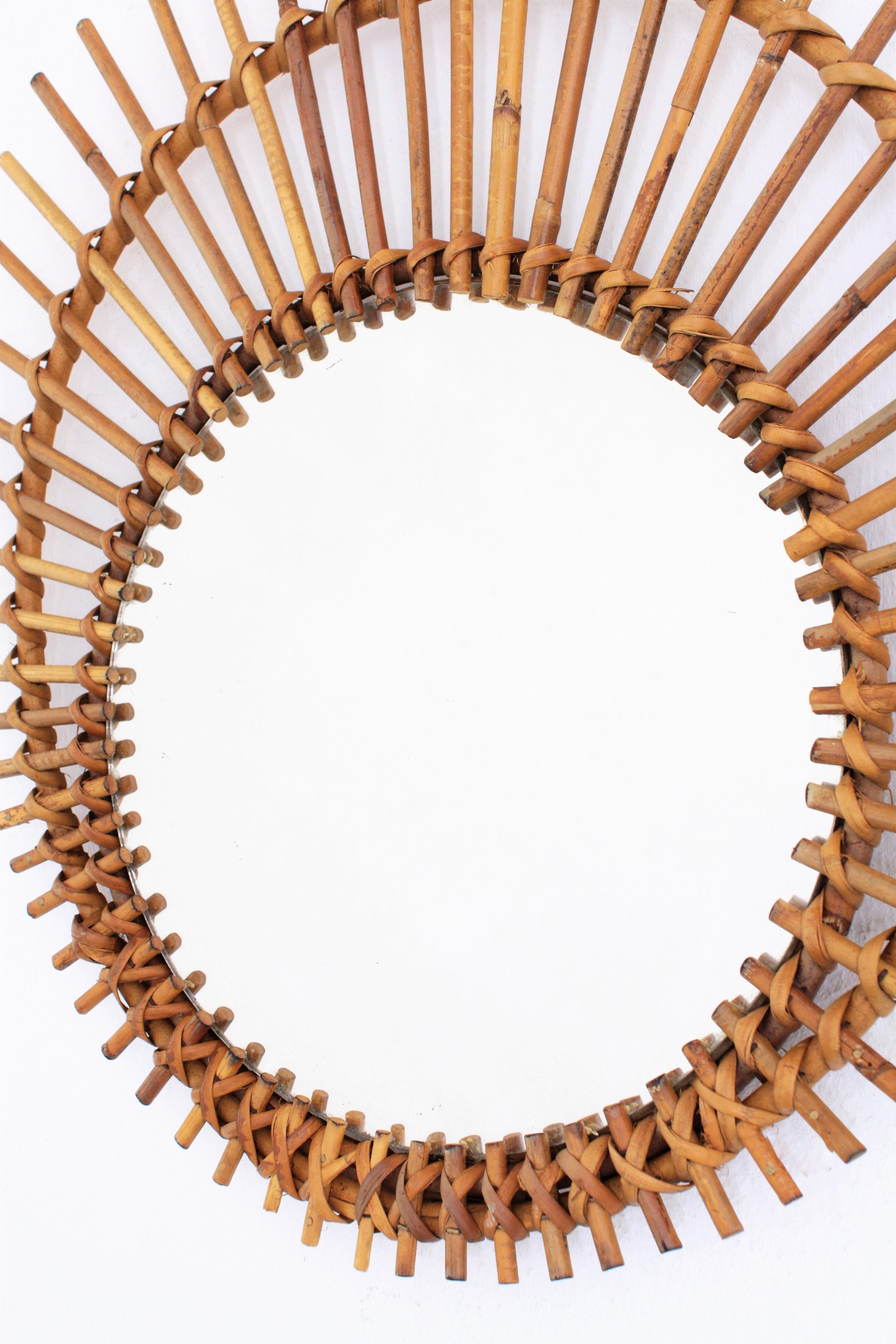 Mid-20th Century Mediterranean Rattan Wicker Asymmetric Ovoid Sunburst Mirror, France, 1960s