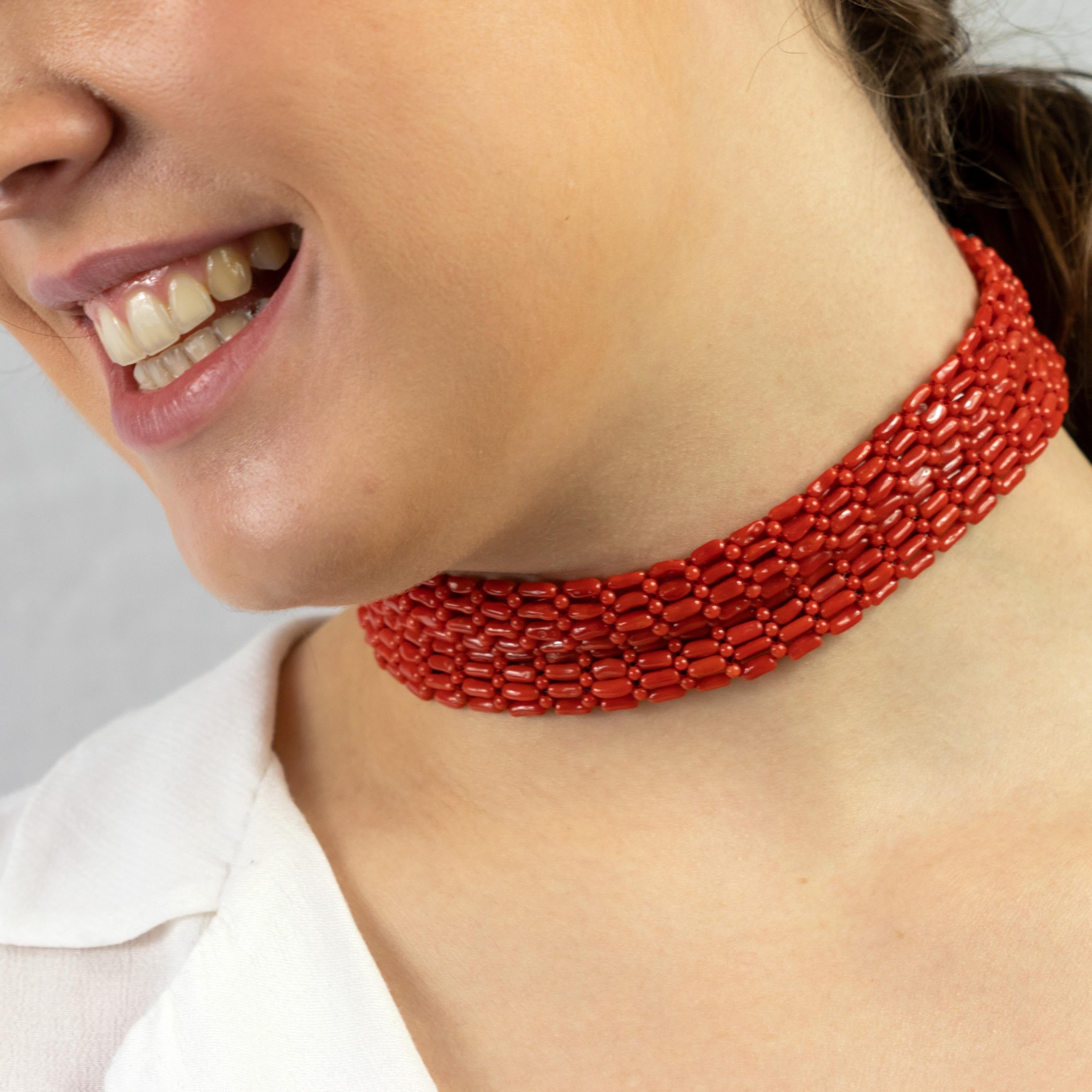 This trendy and fashionable red coral choker necklace brings back the 1940s style. With a touch of modernity and natural bright through the coral woven that interlocks tube and small round beads to give grace and delicacy to the design.
