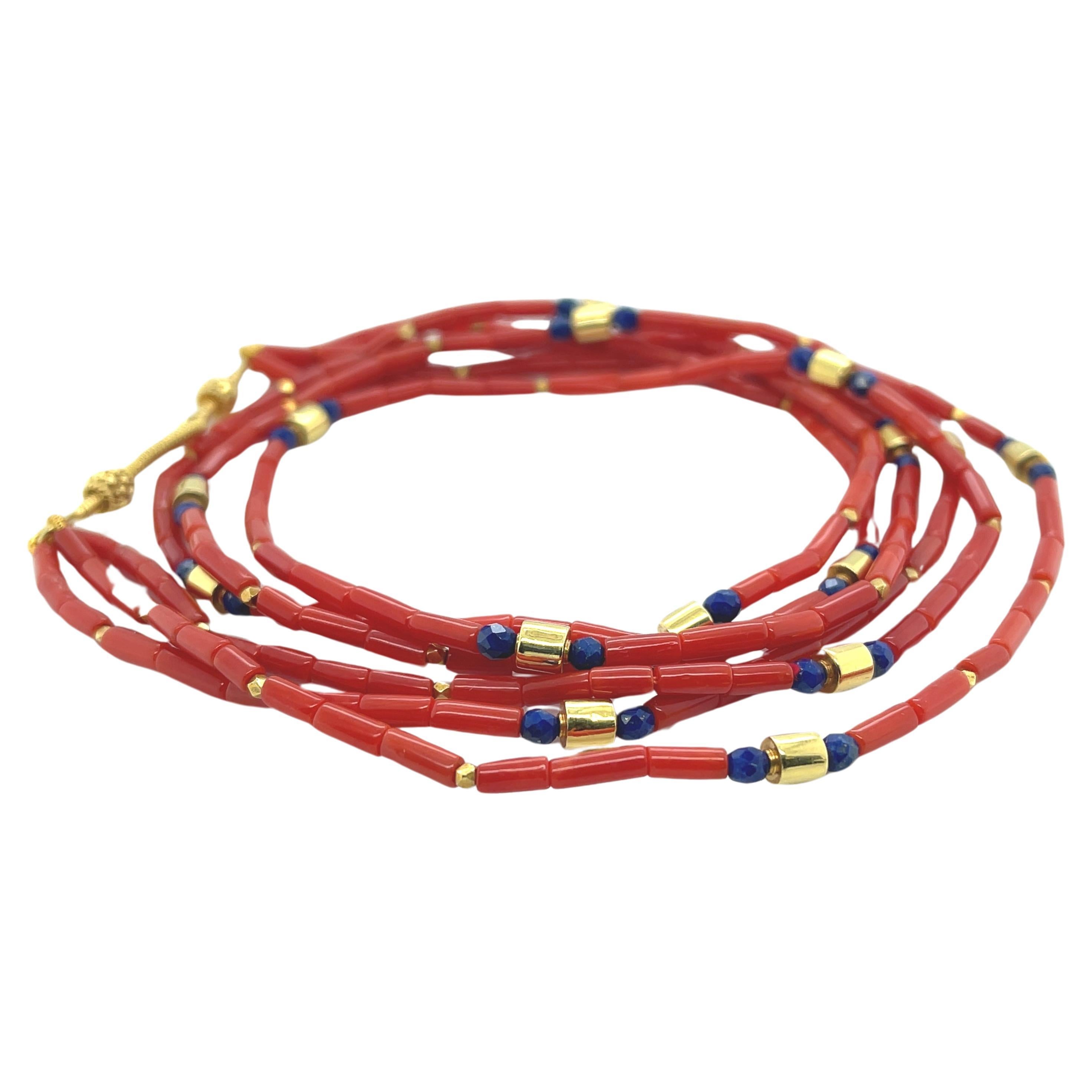 This natural color coral necklace features 3 strands red coral tube beads beautifully arranged with 18k yellow gold spacers and blue lapis accents.  The 5mm coral beads have deep red color that contrasts nicely with the royal blue lapis and bright