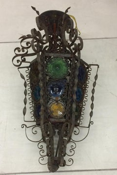 Mediterranean Style Iron Light Fixture with Curly Cues and Colored Glass