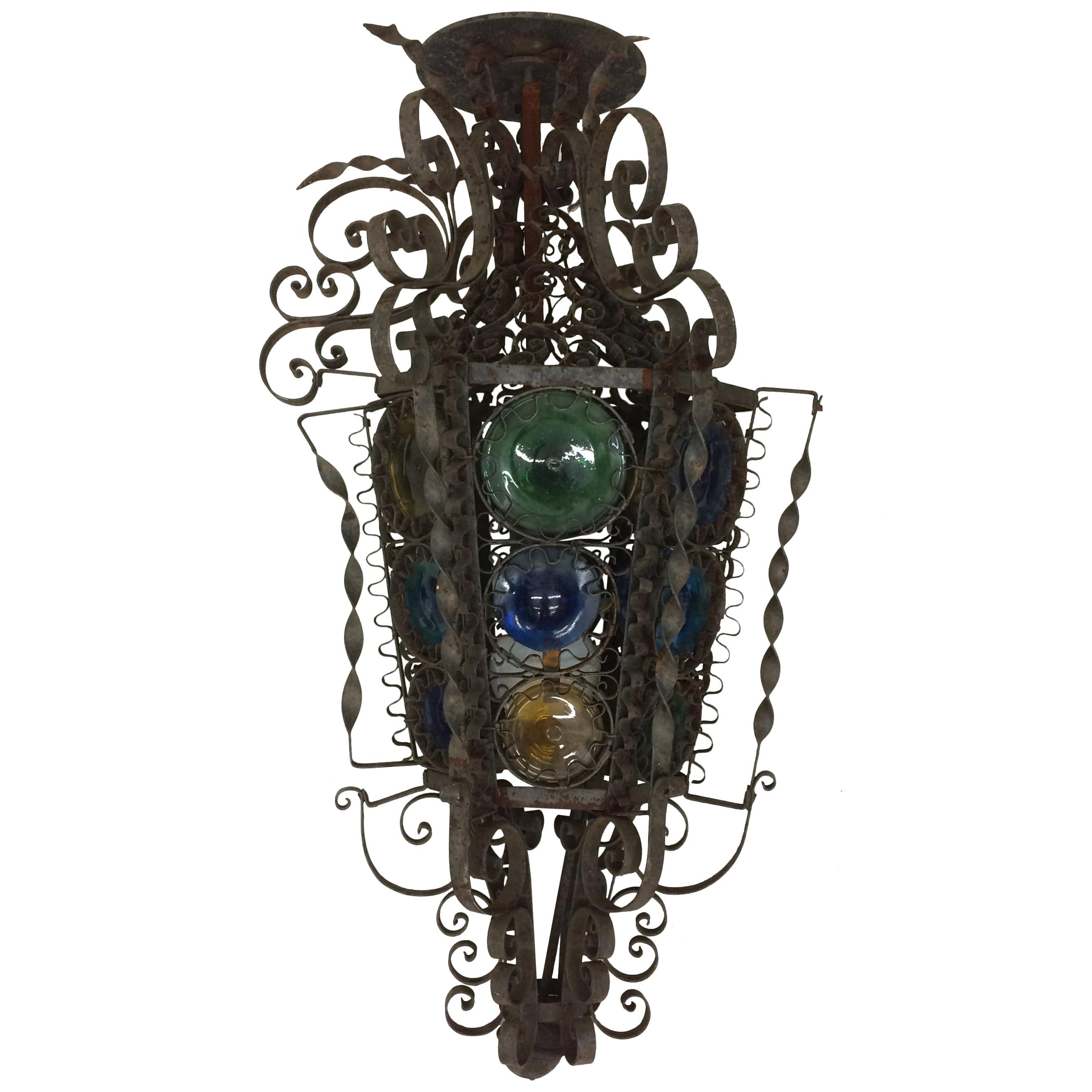 Mediterranean Style Iron Light Fixture with Curly Cues and Colored Glass