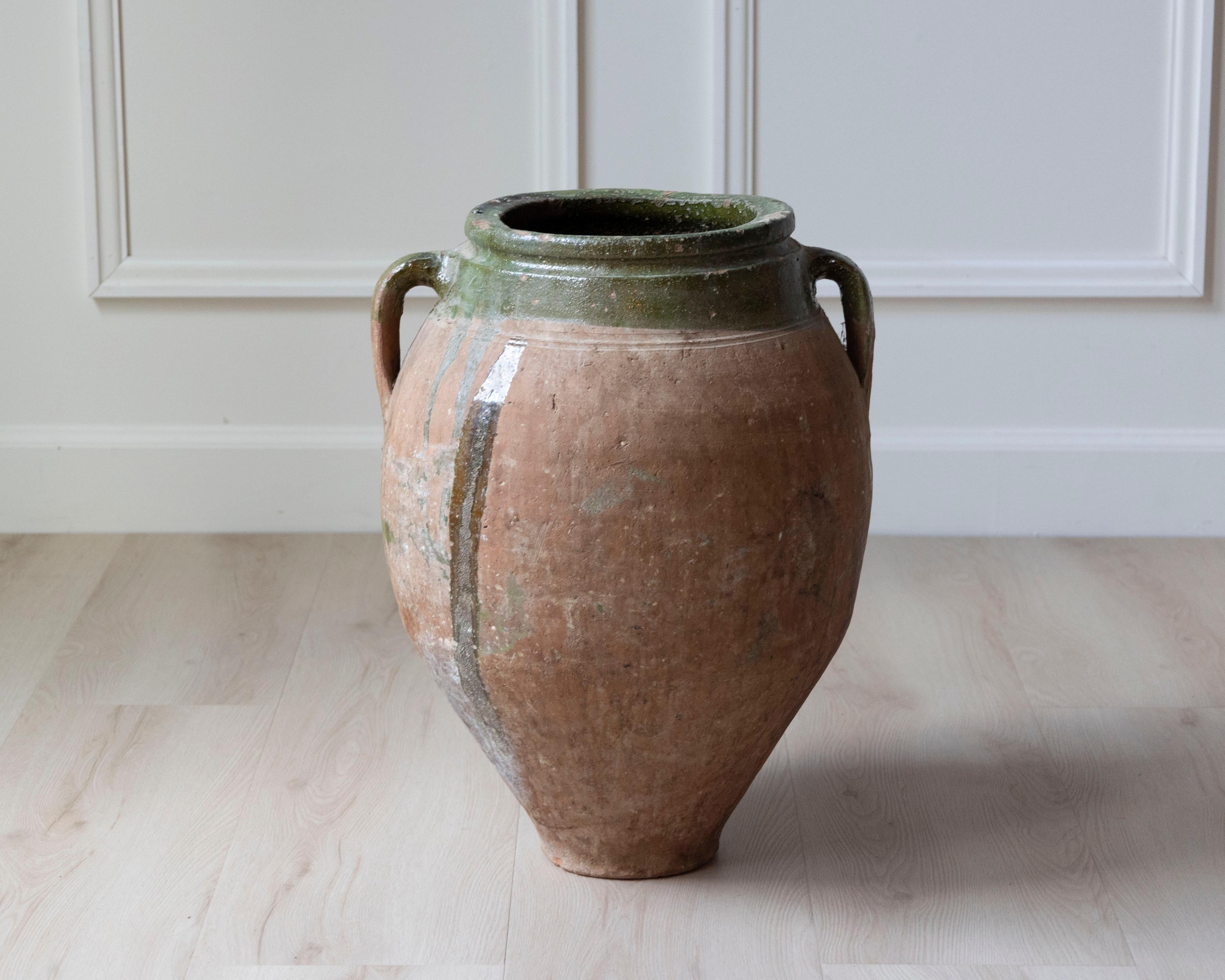 This Mediterranean terracotta jar, dating to the 19th century, is a beautiful example of utilitarian pottery elevated by form and patina. Likely originating from Southern Italy or the South of France, the jar features a classic ovoid silhouette with