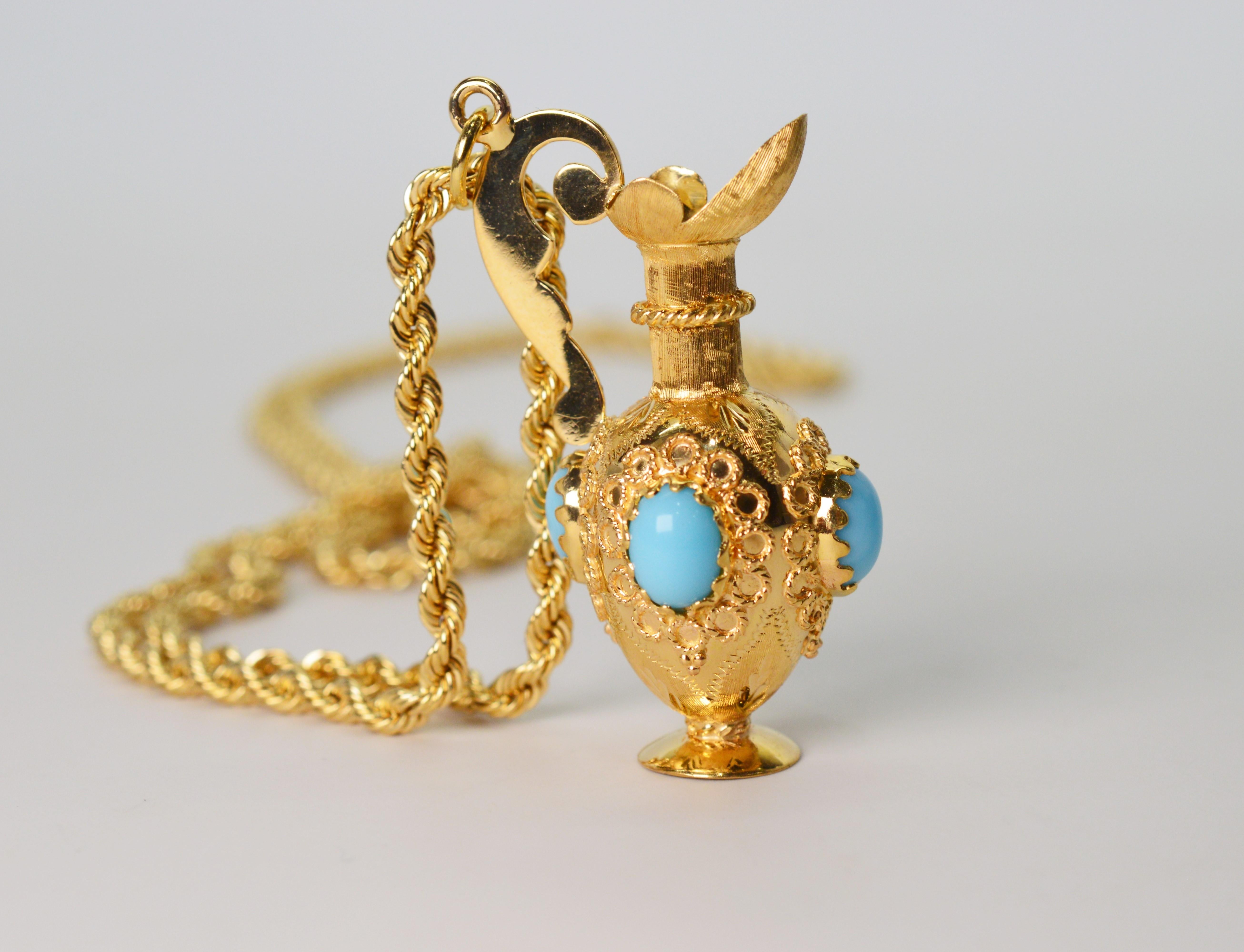 Eye catching and distinctive, this unique and ornate vessel charm is made of brilliant eighteen carat 18K yellow gold and is bejeweled with turquoise cabochon stones. As a pendant, circa 1960, it rests on a substantial and bright 2.5 mm fourteen