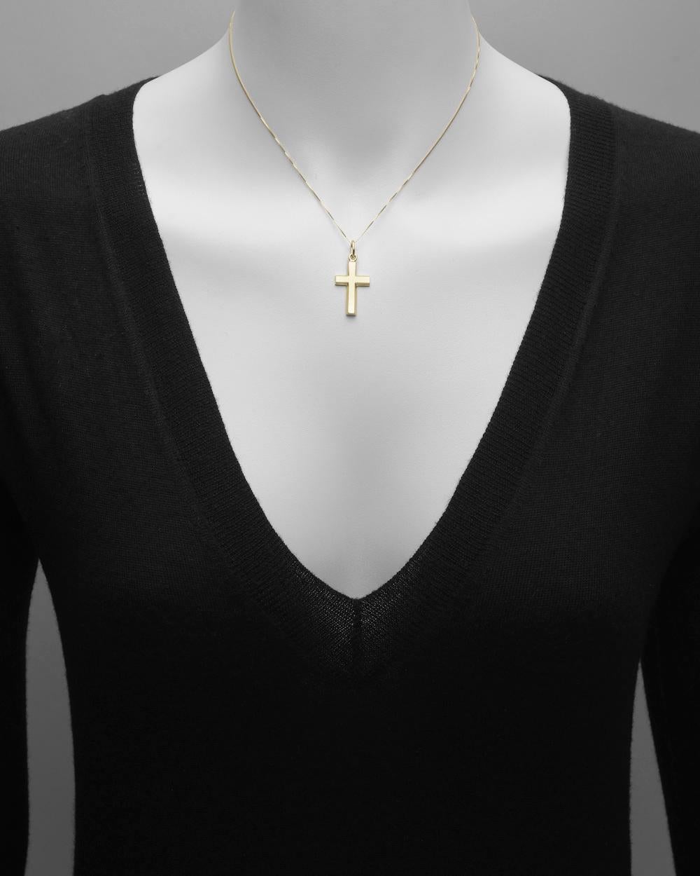 Cross pendant in polished 14k yellow gold with an elegantly beveled edge.
 
- Just under 1