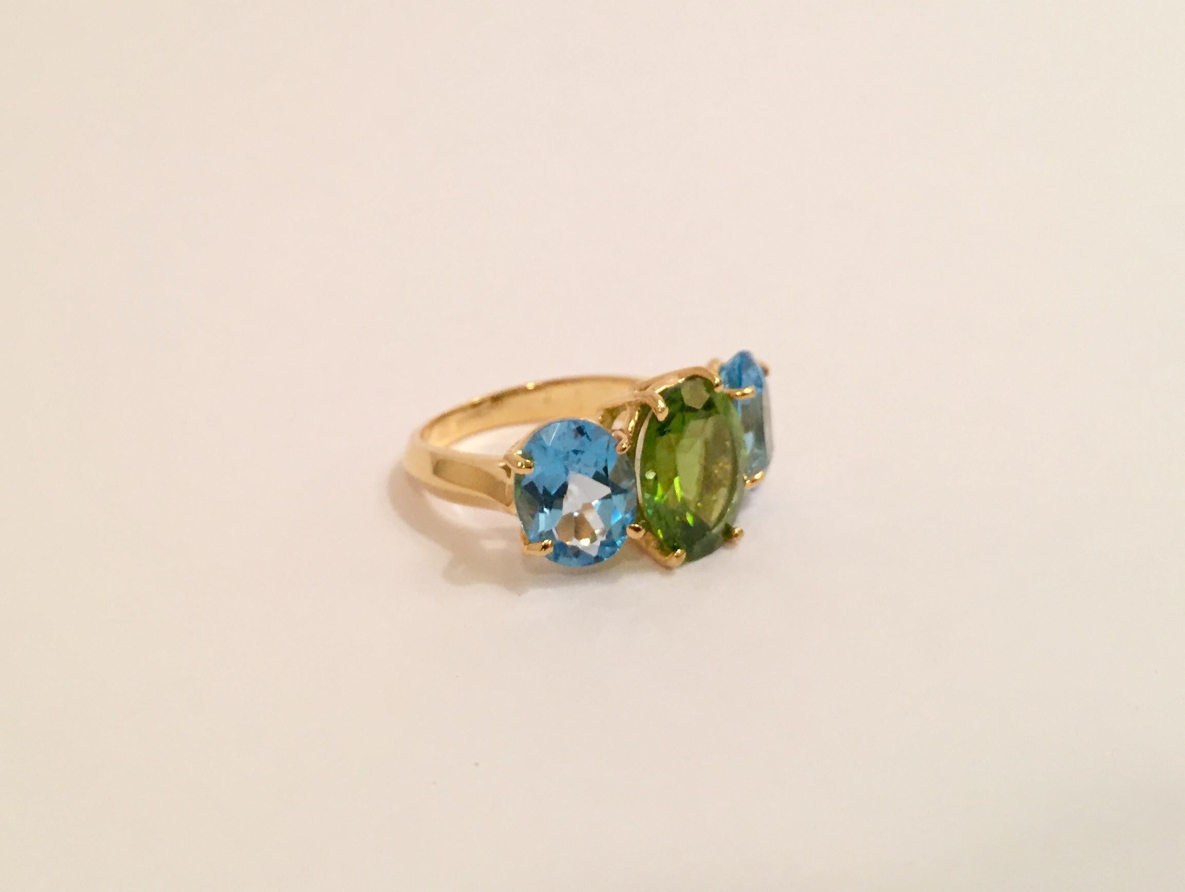 Medium 18kt Yellow Gold Gum Drop ring with Peridot (approximately 5 cts)and Blue Topaz (approximately 4 cts each),

Specifications: Length: 7/8