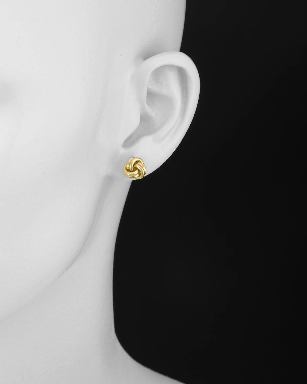 Three-loop knot earstuds in polished 18k yellow gold. Posts with friction backs for pierced ears. 0.35