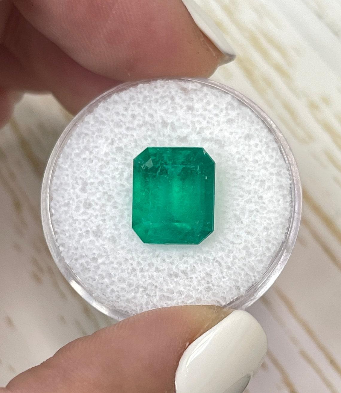 Stone: Emerald
Weight: 4.50-carats
Shape: Emerald Cut
Clarity: Transparent to Semi-Transparent
Luster: Very Good
Color: Vivid Green
Measurements: 10.85mm x 9.25mm x 6.70mm
Geographic Origin: Colombia
Treatment: Natural, Oiling

Comments: Due to