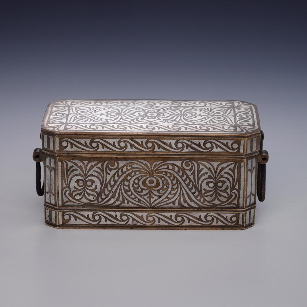Small Betel Nut Box, Maranao, Southern Philippines (Mindanao).
Bronze with bordered silver inlay design overall of a symmetrical floral tendril vine pattern referred to as “the okir pattern”,  a traditional design for the Maranao people. This betel