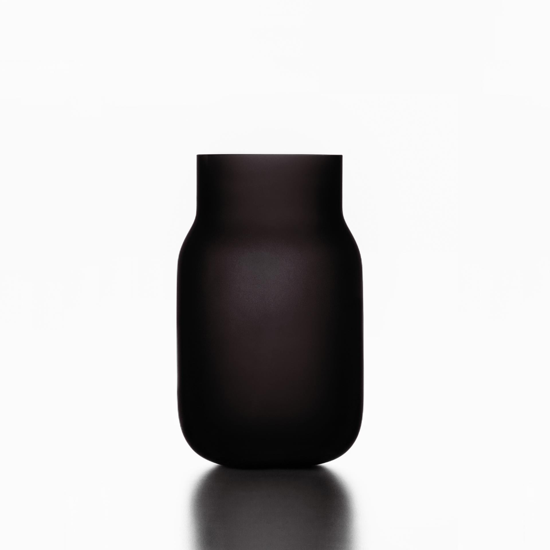 Medium black Bandaska matte vase by Dechem Studio.
Dimensions: D 15 x H 25 cm.
Materials: glass.
Available in 4 sizes: D 15 x H 25/ D 18 x H 24/ D 9 x W 31/ D 22 x H 33 cm.
Available in black, uranium yellow, dark blue.

Hand-blown into beech
