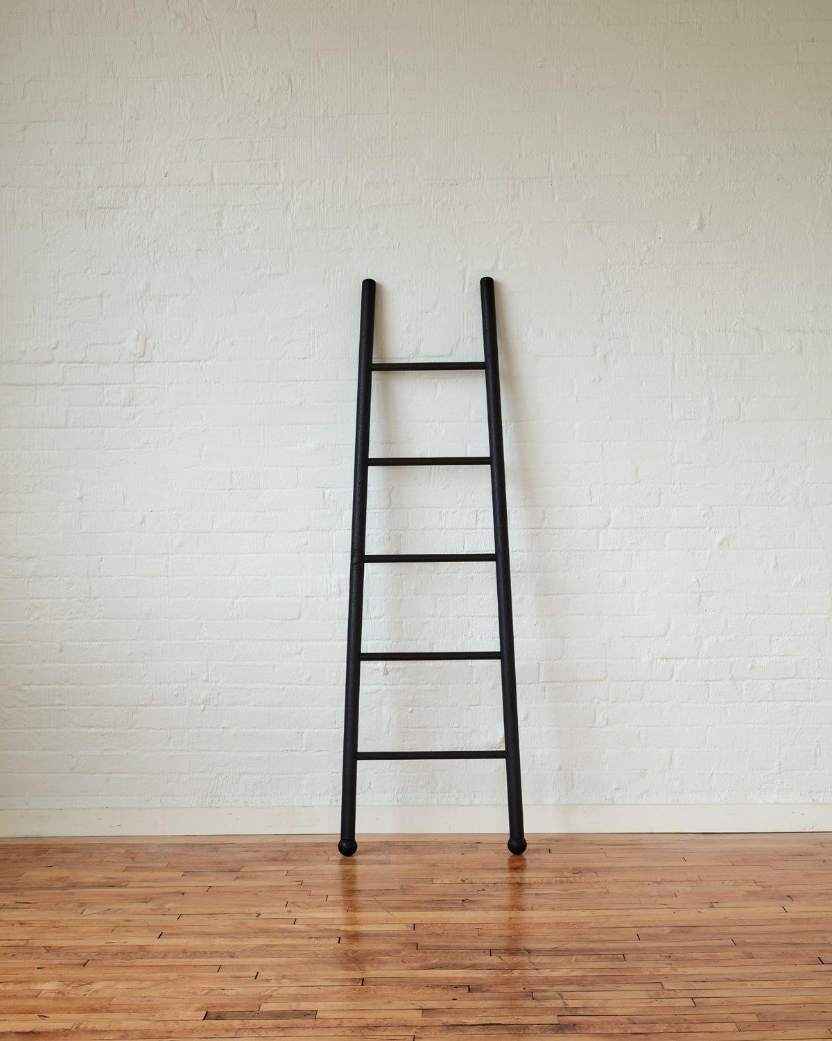 Our Black Bloak Ladders are made of solid white oak finished with ink to blacken them while still letting the natural beauty of the wood grain come through. We use them to display blankets, towels or scarves. Great at the beach house for bathing