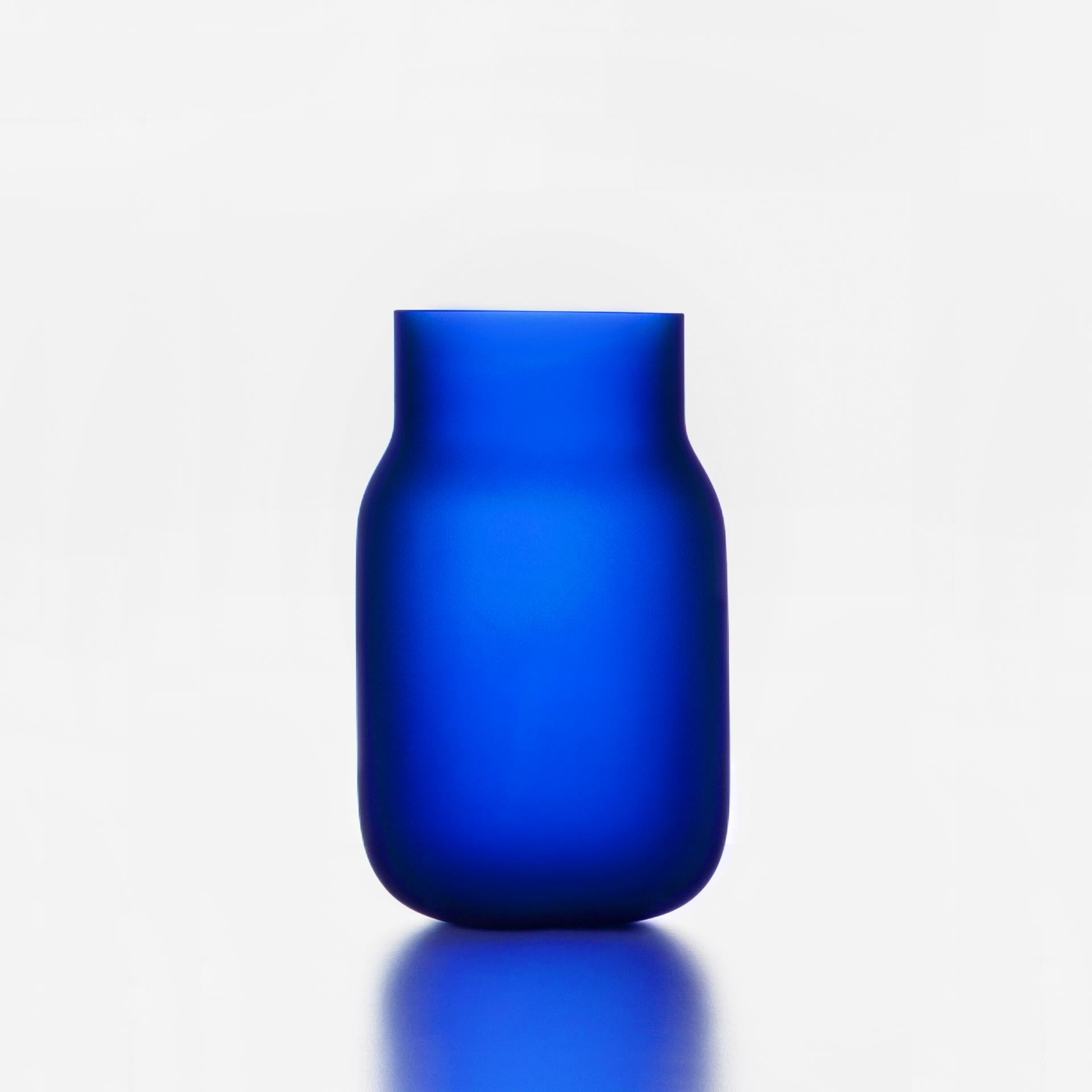 Medium Blue Bandaska Matte vase by Dechem Studio.
Dimensions: D 15 x H 25 cm.
Materials: glass.
Available in 4 sizes: D 15 x H 25/ D 18 x H 24/ D 9 x W 31/ D 22 x H 33 cm.
Available in black, uranium yellow, dark blue.

hand blown into