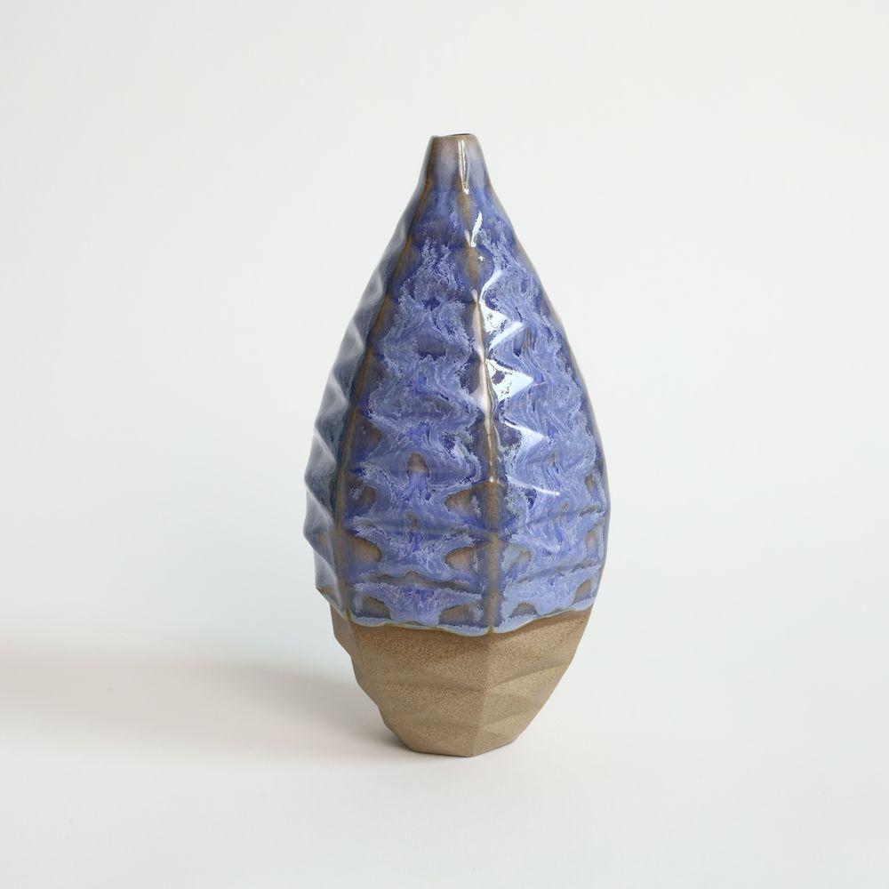 Medium Bottle in Coral Blue
The Medium Bottle is a unique and captivating piece of ceramic art that is sure to elevate any space. Its wide waistline and small opening create the perfect canvas for a single or few dried flowers, making it an ideal