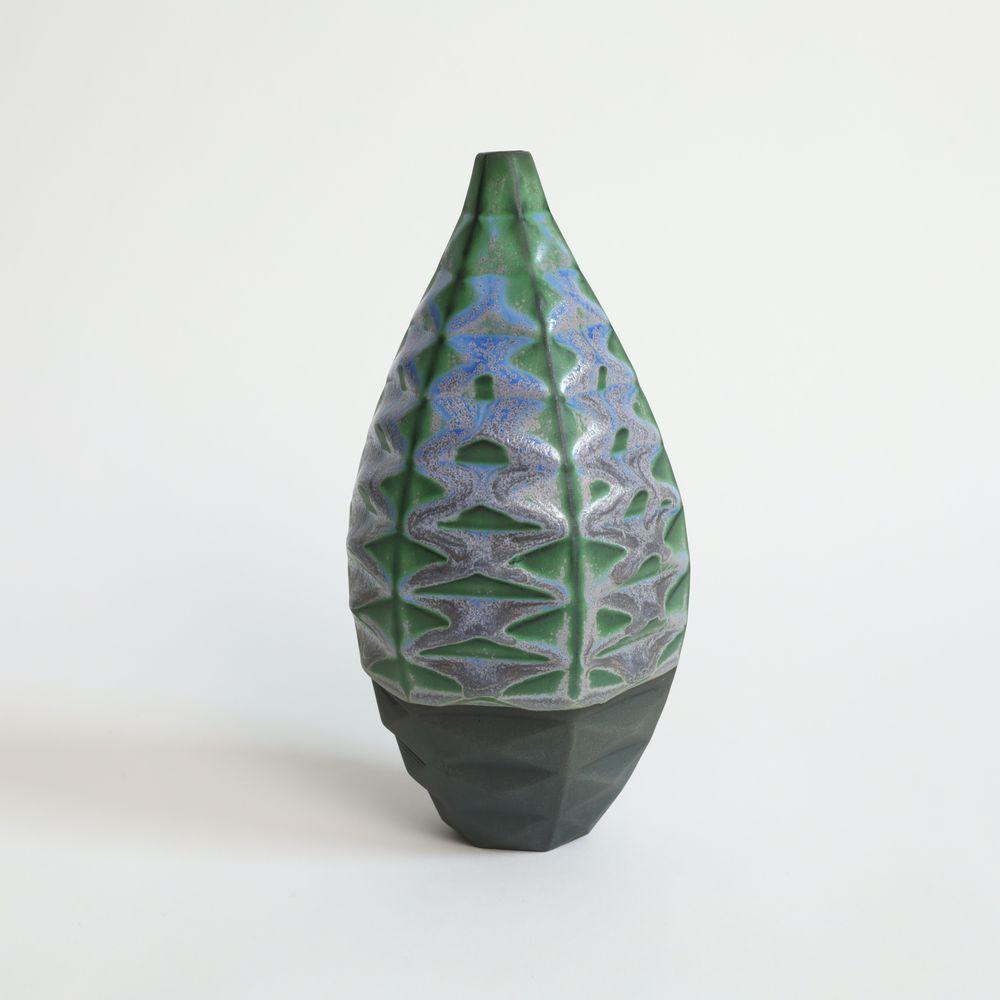 Medium Bottle in Nebula
The Medium Bottle is a unique and captivating piece of ceramic art that is sure to elevate any space. Its wide waistline and small opening create the perfect canvas for a single or few dried flowers, making it an ideal vessel