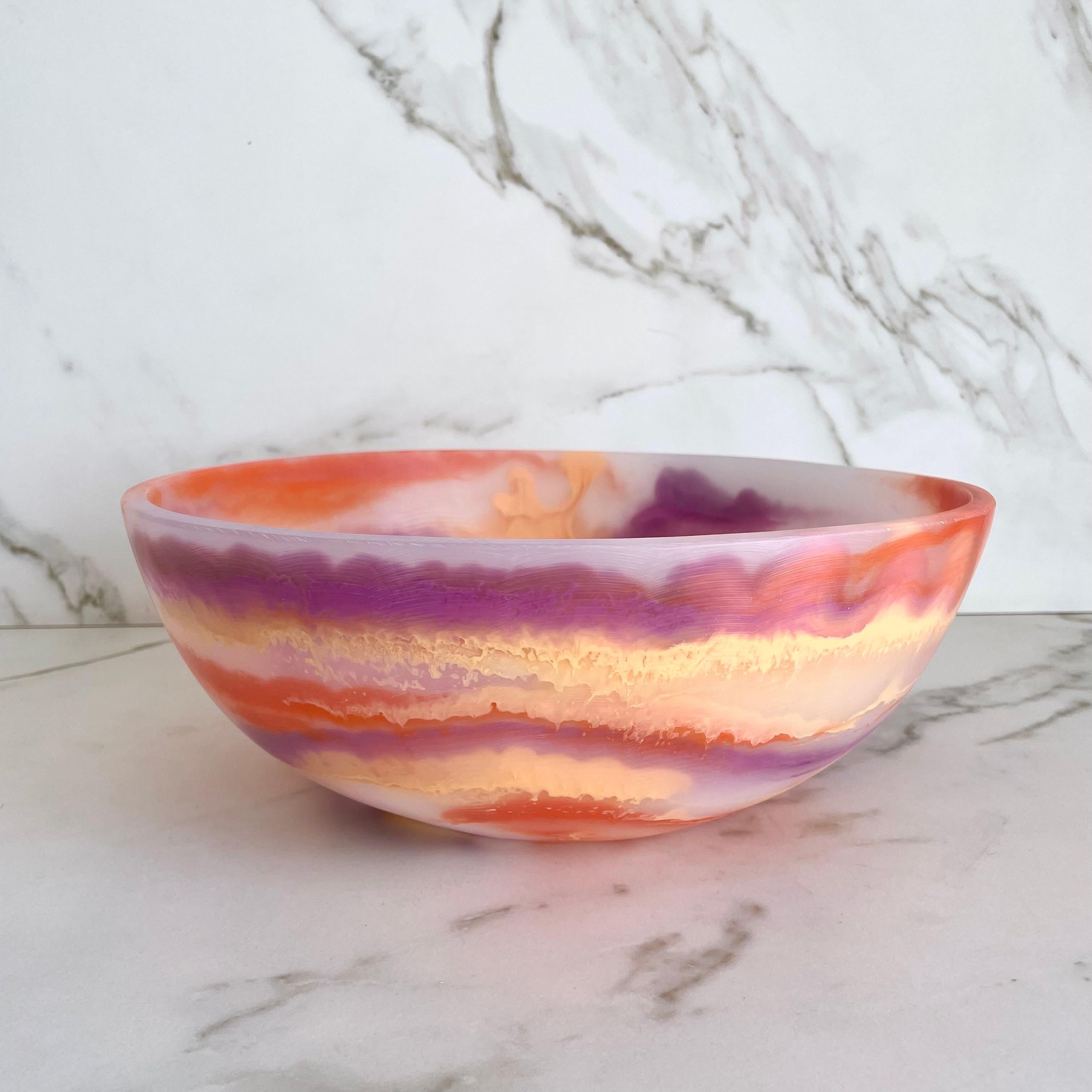 Our colorful bowl is handmade in traslucid white resin with marbled texture in purple, light orange and orange. Its fun and colorful design makes it a statement piece and can be used as decor,fruit platter or to serve cold food.

Designed by Paola
