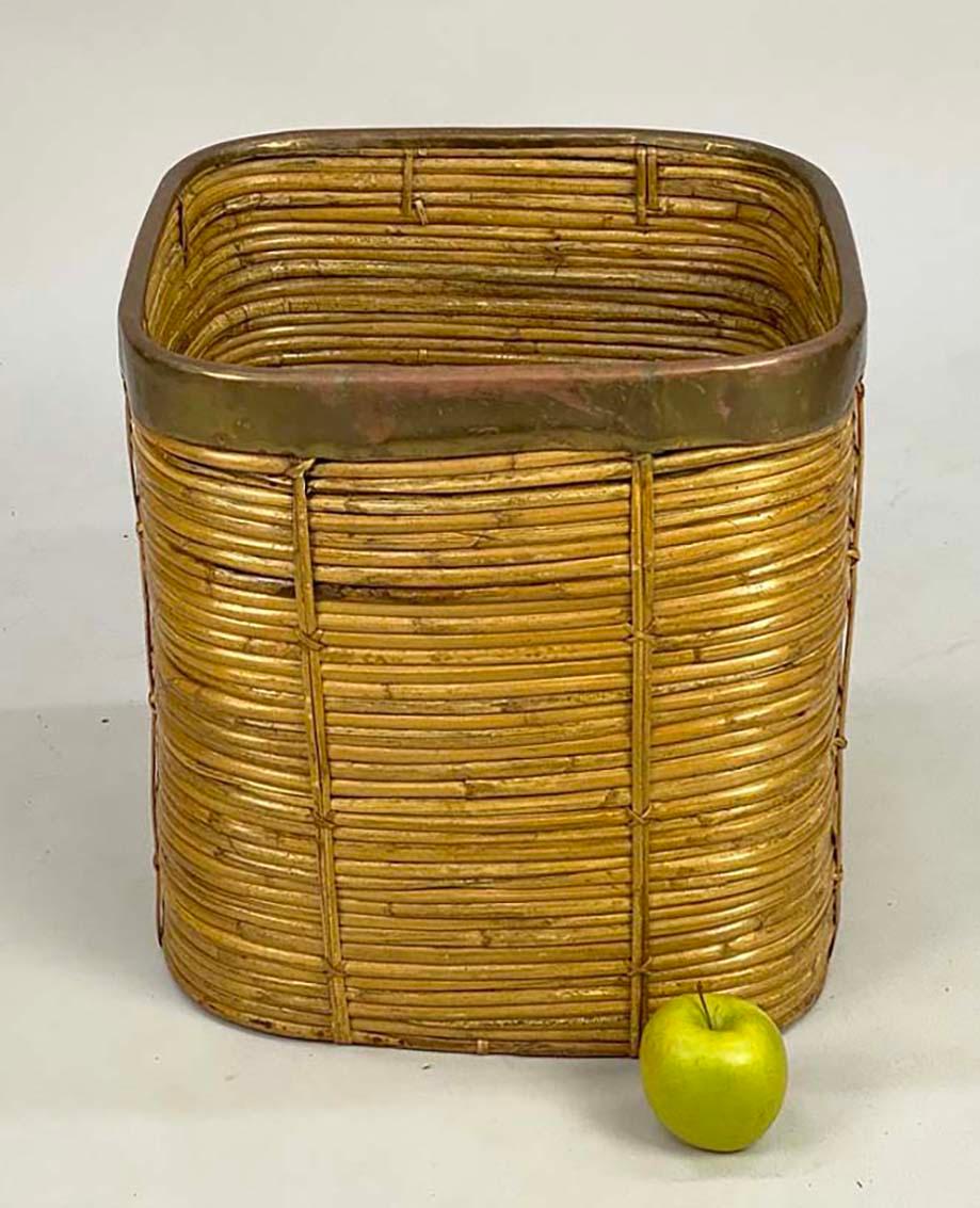 Here is a versatile-sized pencil rattan and brass basket that can be used for many things--for storage, as a wastebasket or as a planter for a larger plant. It measures 15.75