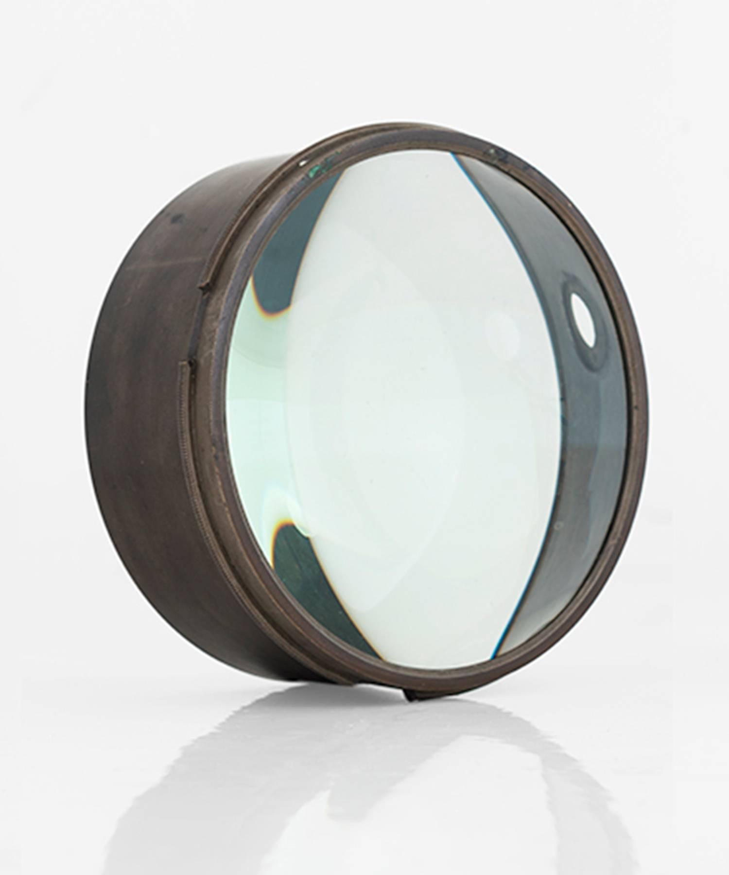 Medium brass magnifying glass lens, circa 1910.

A collection of magnifying glass lenses salvaged from magic Lantern condensers and telescopes. One encased in brass, one encased in painted steel.