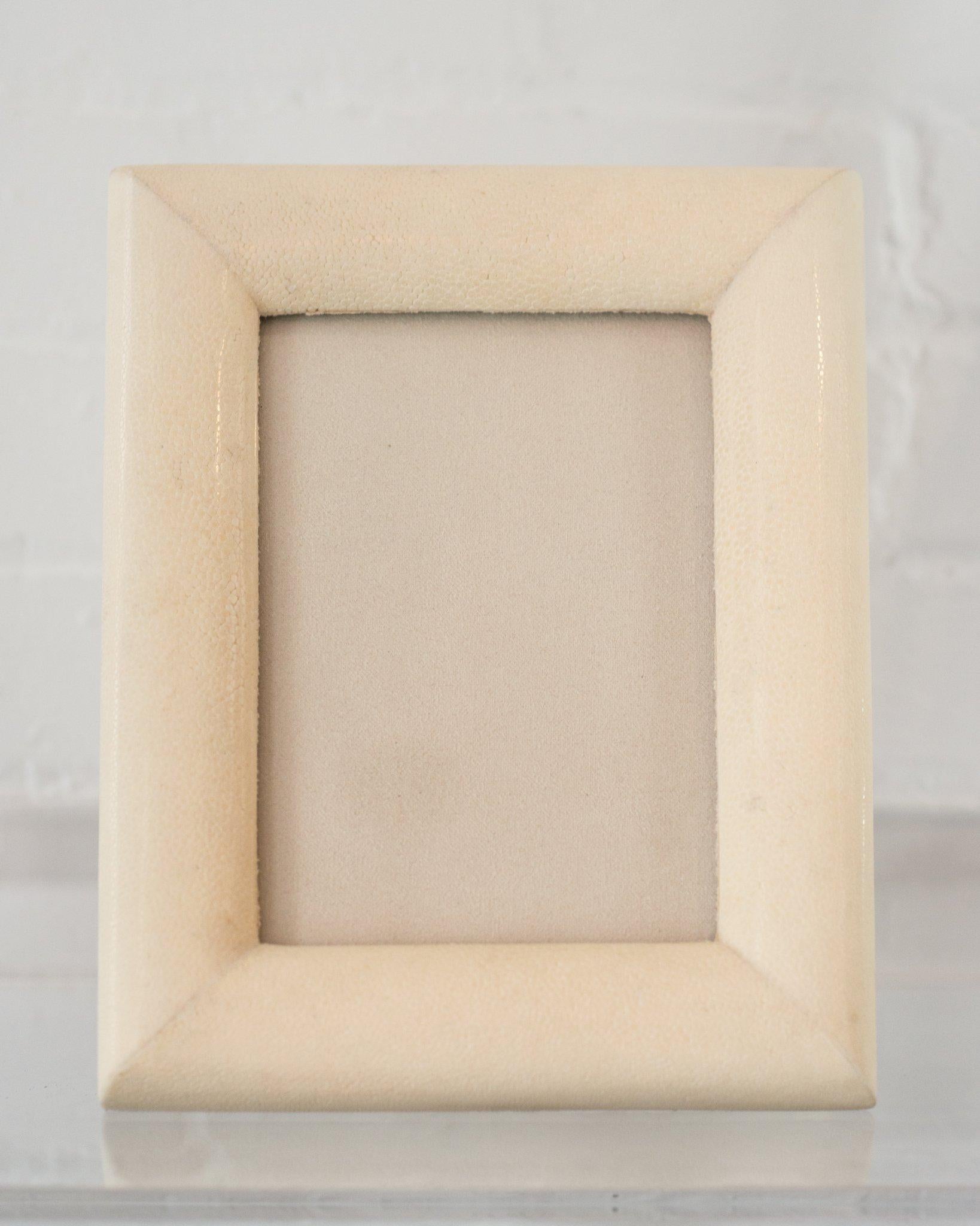 A medium picture frame in cream shagreen leather and walnut, backed in suede. Accommodates one 5 x 7
