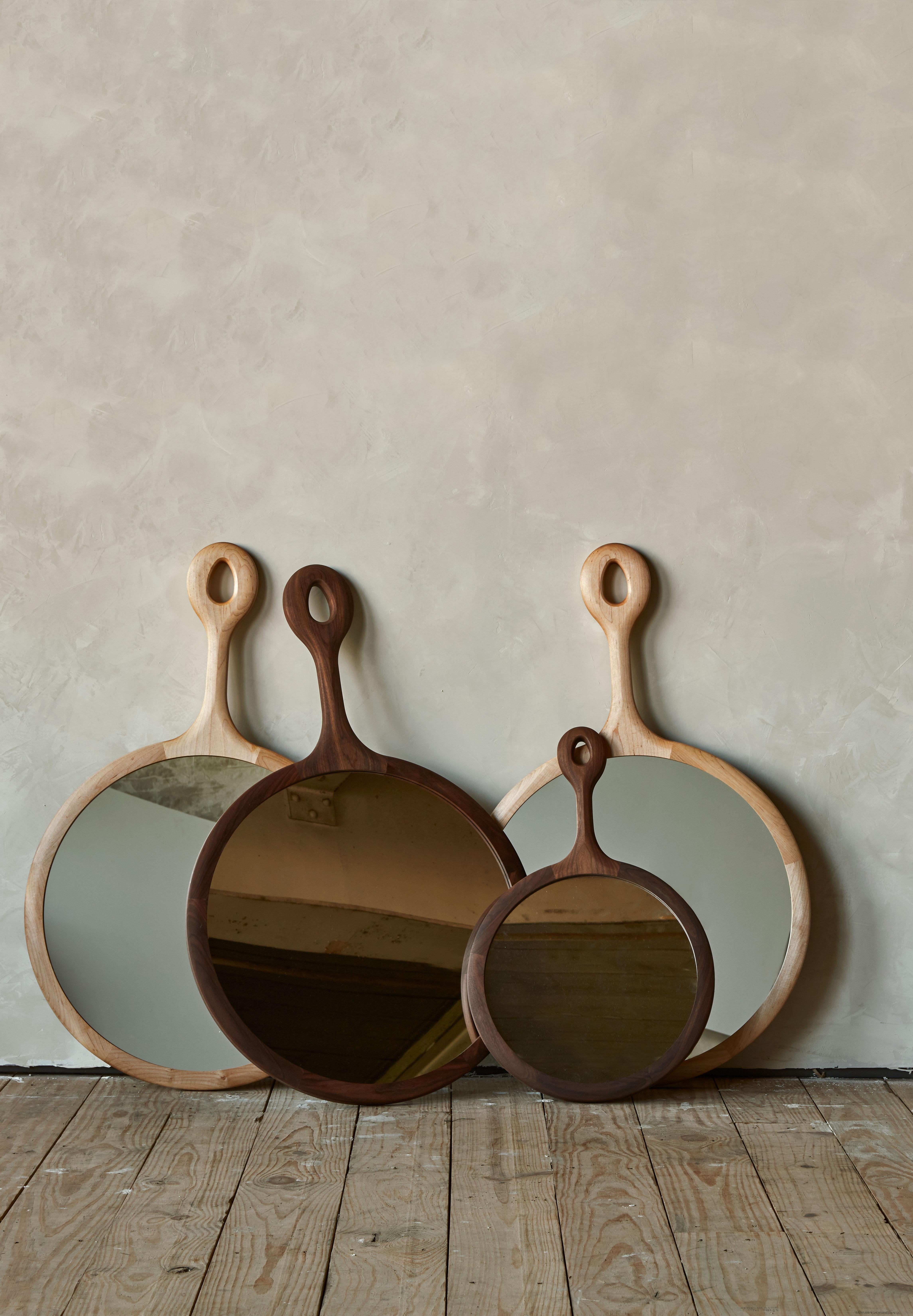 The Sophia Mirror is framed in wooden dark walnut with a long neck resembling an oversized hand mirror. Handcrafted in Pennsylvania, the Sophia comes with a hand-hammered iron peg for hanging. The medium is a lovely size above a dresser or in a