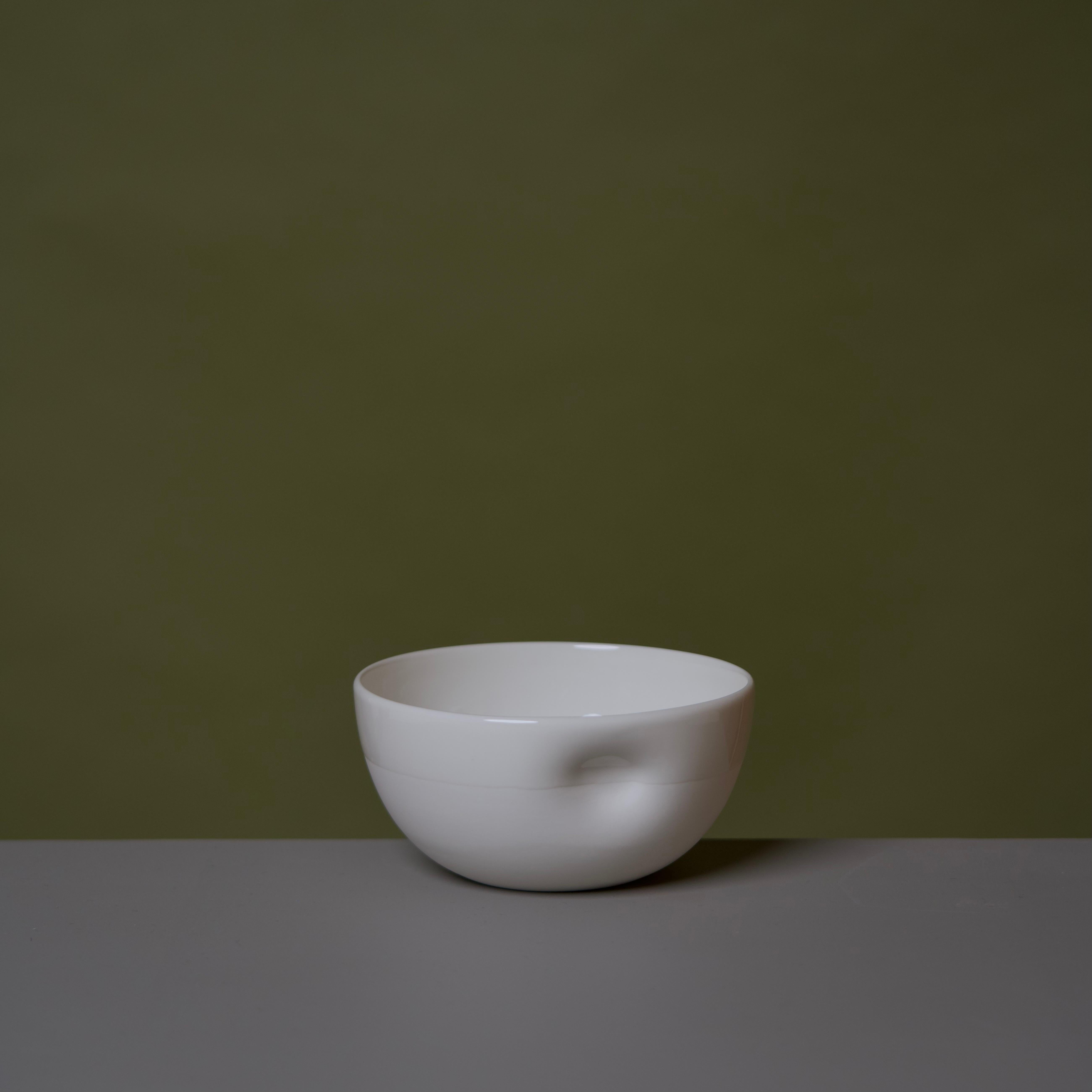 Middle Kingdom dimpled porcelain bowls are designed by Carola Zee of Rotterdam, Holland. Each bowl is molded and then dimpled by the hand of the potter to create a unique and comfortable hold. There are three sizes available, three colors, and