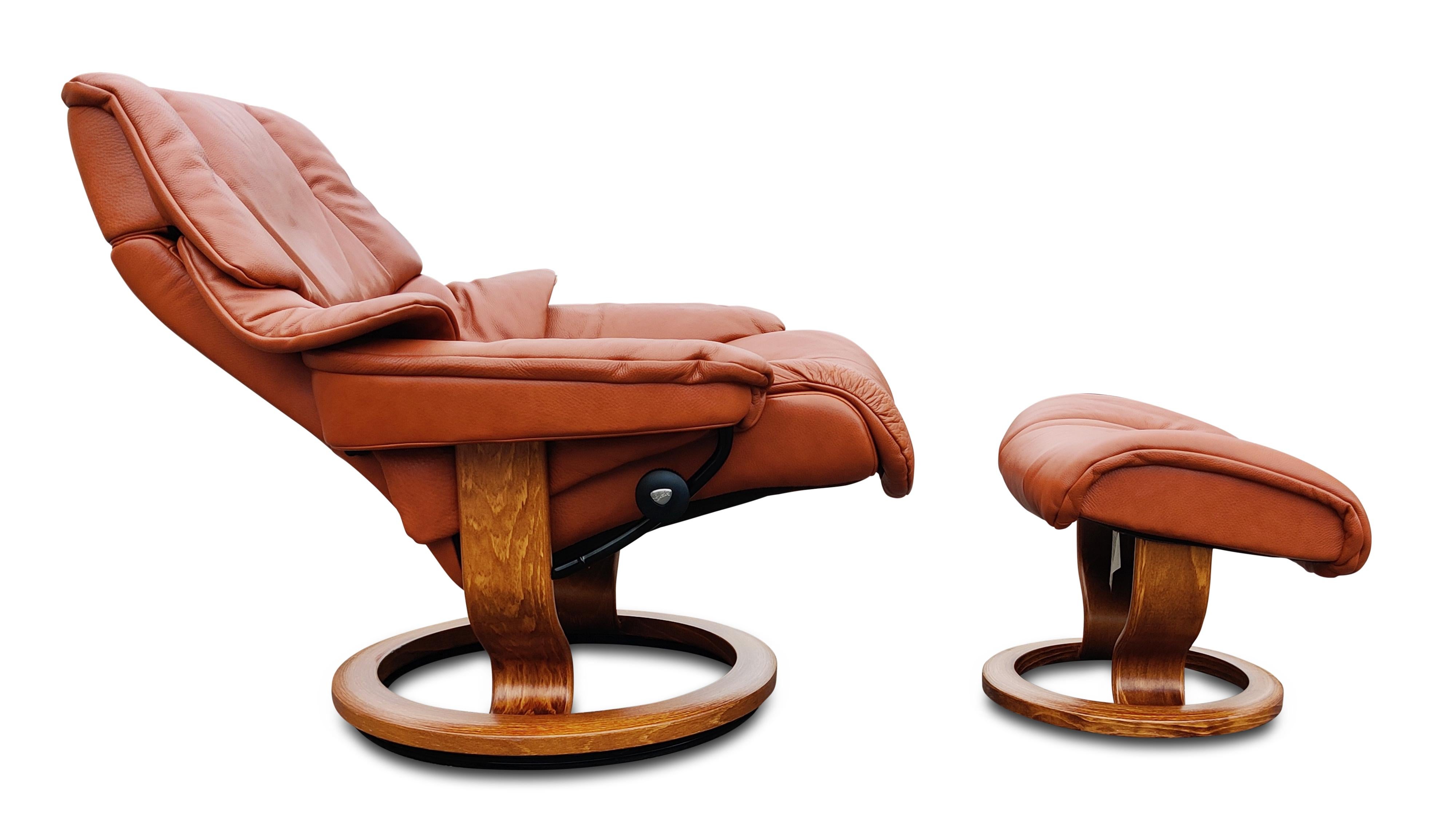 A Scandinavian style recliner or adjustable lounge and ottoman by Ekornes, their Stressless brand. With teak-plywood wood bases and metal frames and genuine leather upholstery, this is a comfortable brown color leather recliner on a round