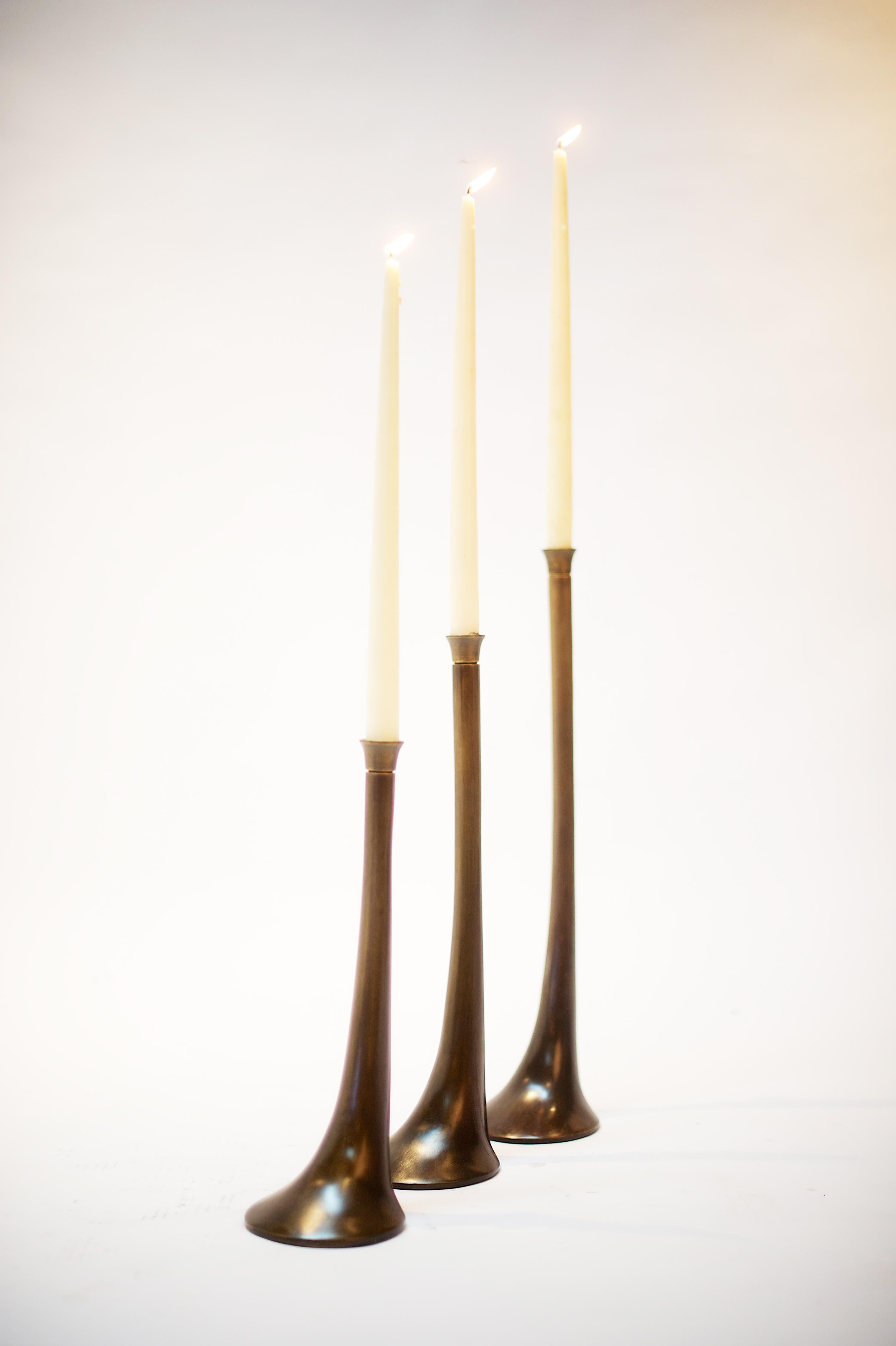 The Elm Candleholders are cast using the lost wax method in an elegant sculptural shape. Shown in our antique bronze finish, with highlights (ombre). Comes in 3 sizes.