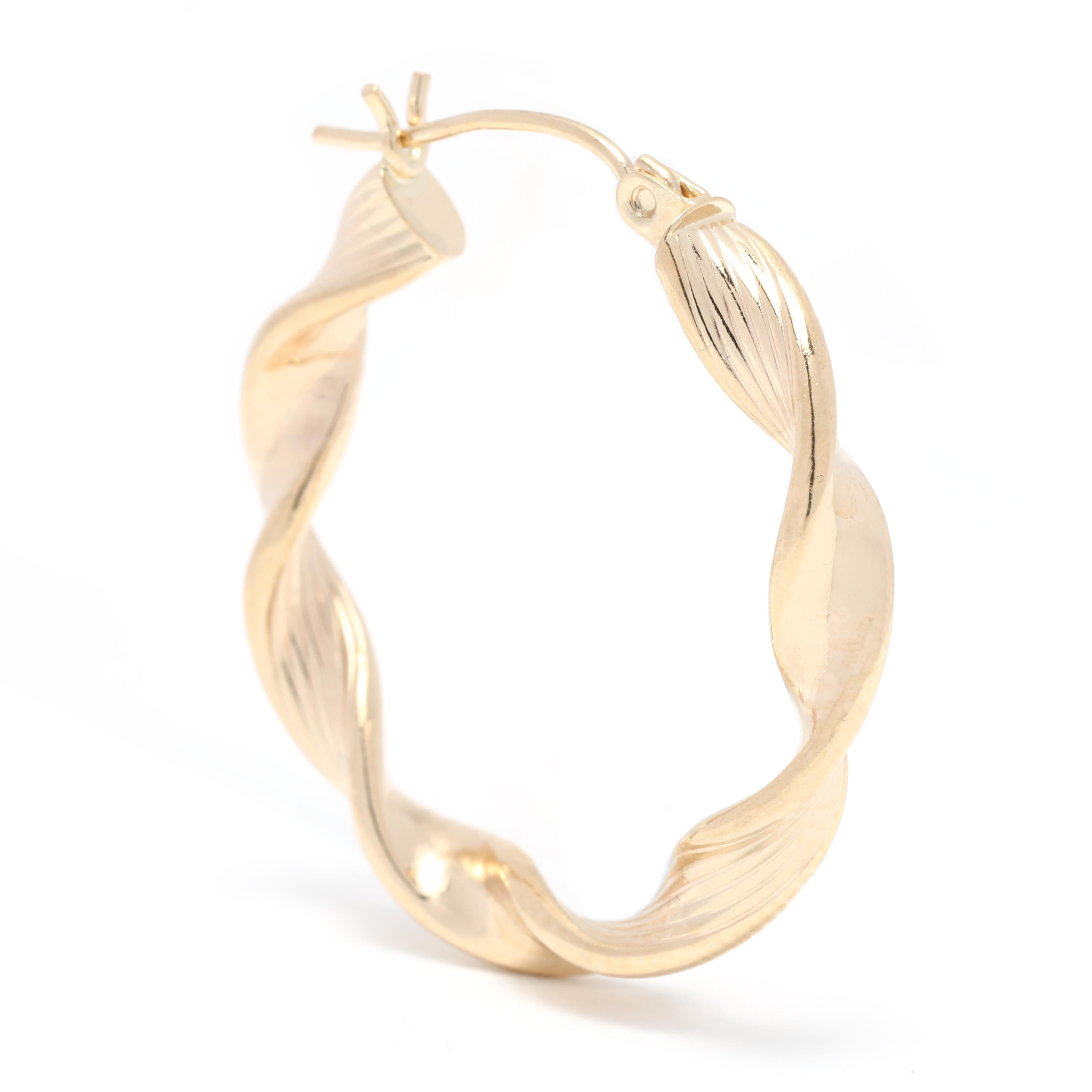 These Medium Gold Twist Hoop Earrings are a beautiful and timeless addition to any jewelry collection. Handcrafted from 14K yellow gold, these minimalist hoop earrings measure 1 inch in length and feature a simple twist design. Perfect for everyday